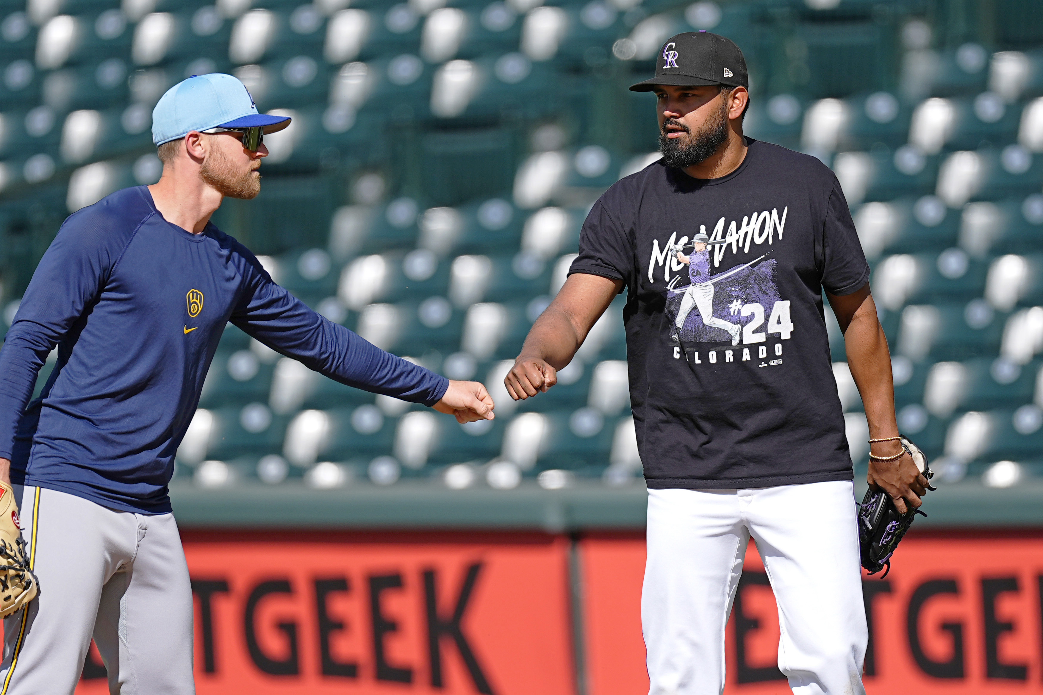 Milwaukee Brewers first baseman Jake Bauers, left, greets injured Colorado Rockies starting pitcher German Marquez before a baseball game Tuesday, July 2, 2024, in Denver. 