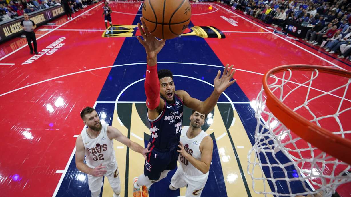 FILE - Philadelphia 76ers' Tobias Harris, center, goes up for a shot between Cleveland Cavaliers' Dean Wade, left, and Georges Niang during the first half of an NBA basketball in-season tournament game, Tuesday, Nov. 21, 2023, in Philadelphia. The NBA has agreed to terms on its new media deal, an 11-year agreement worth $76 billion that assures player salaries will continue rising for the foreseeable future and one that will surely change how some viewers access the game for years to come.