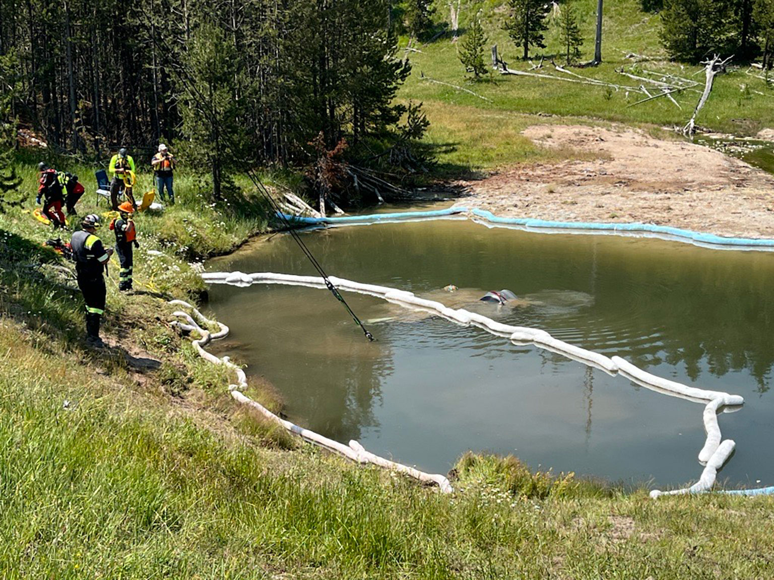 A car inadvertently drove into a geyser at Yellowstone National Park on Thursday. All five people in the car were taken to the hospital but did not have life-threatening injuries.