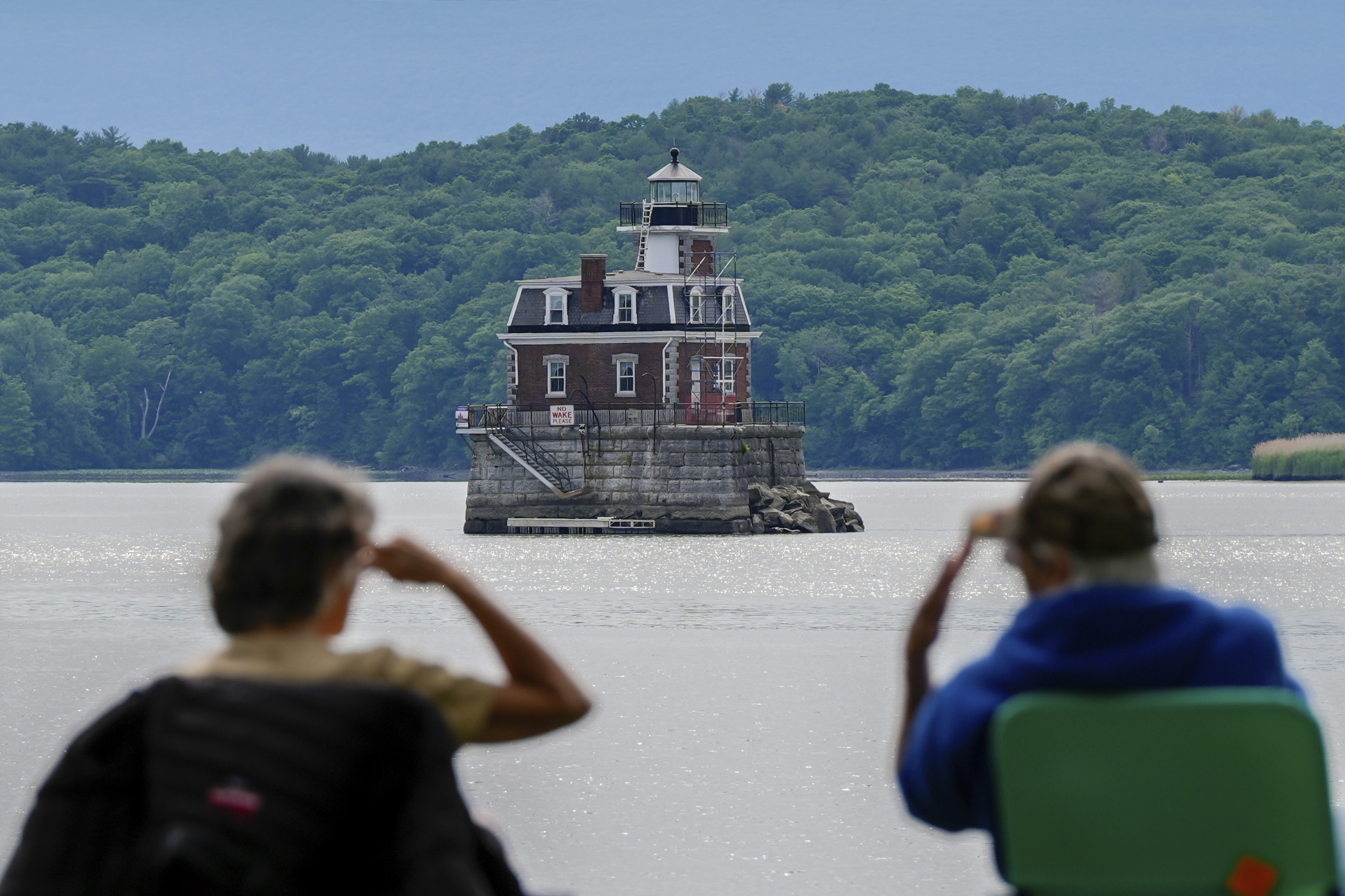 People look at the Hudson-Athens Lighthouse, Wednesday, June 12, 2024, in Hudson, N.Y.