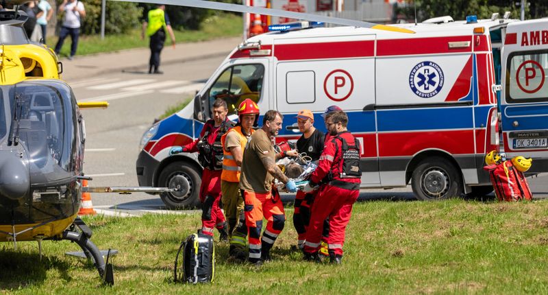 Rescuers attend a miner after a pit in southern Poland was struck by an earth tremor in the Rydultowy mine, in Rydultowy, Poland, Thursday.