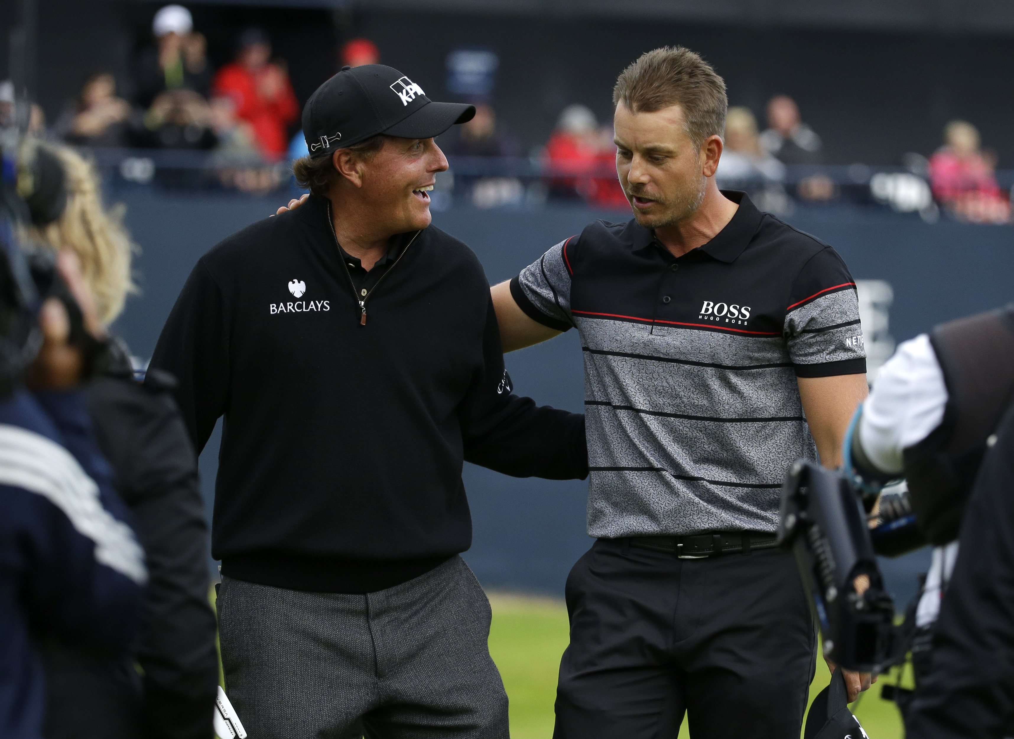 FILE - Phil Mickelson of the United States, left, congratulates Henrik Stenson of Sweden for winning the British Open Golf Championships at the Royal Troon Golf Club in Troon, Scotland, Sunday, July 17, 2016. They return to Royal Troon this week with memories fresh of their great duel. 