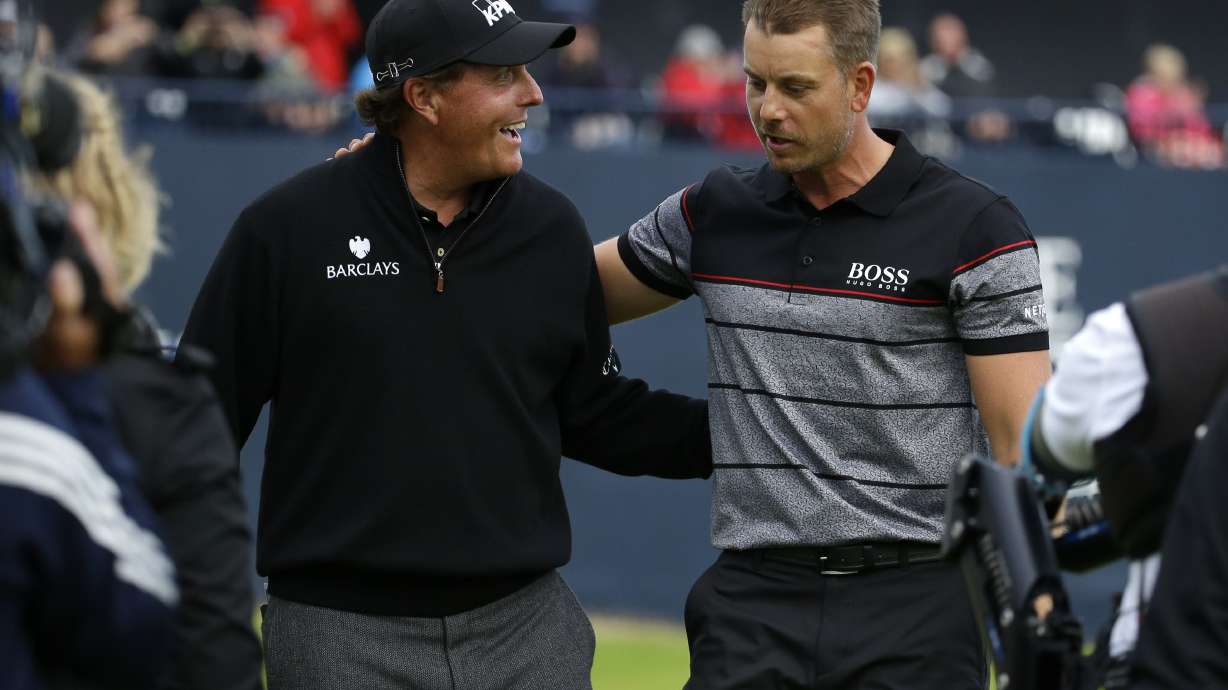 FILE - Phil Mickelson of the United States, left, congratulates Henrik Stenson of Sweden for winning the British Open Golf Championships at the Royal Troon Golf Club in Troon, Scotland, Sunday, July 17, 2016. They return to Royal Troon this week with memories fresh of their great duel.