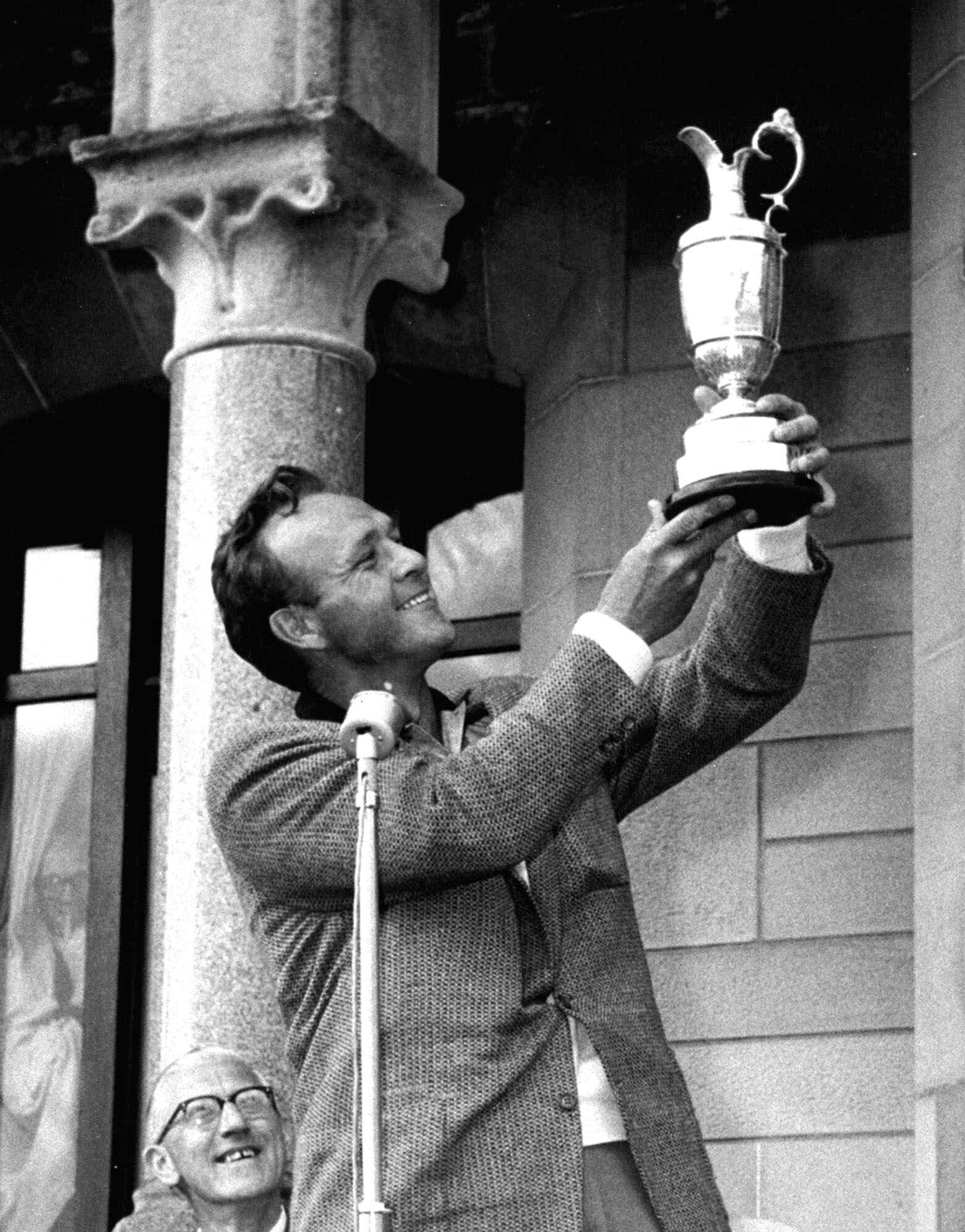 FILE - British Open champion Arnold Palmer poses with his trophy held high for all to see at the presentation ceremonies at Troon, Scotland, July 13, 1962. Palmer was the first American winner at Troon. 