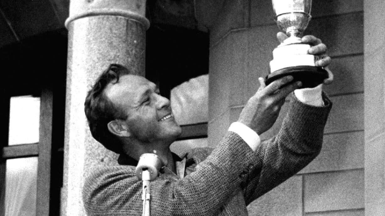 FILE - British Open champion Arnold Palmer poses with his trophy held high for all to see at the presentation ceremonies at Troon, Scotland, July 13, 1962. Palmer was the first American winner at Troon.