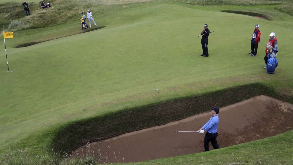 FILE - Rory McIlroy, of Northern Ireland, hits out of bunker onto the eighth green during the second round of the British Open Golf Championship at the Royal Troon Golf Club in Troon, Scotland, Friday, July 15, 2016. McIlroy returns to Royal Troon while trying to move past his U.S. Open collapse.