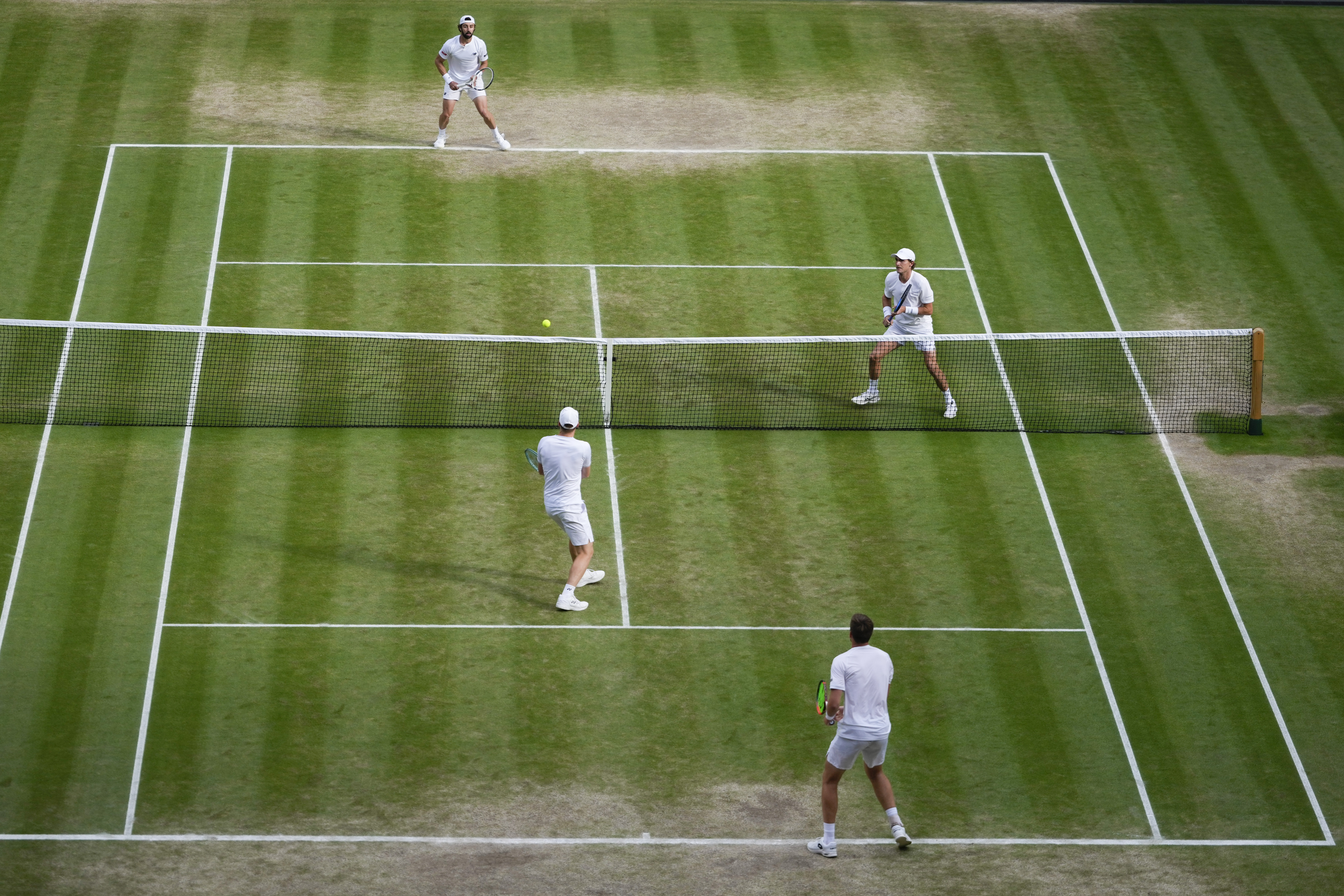 Australia's Max Purcell and compatriot Jordan Thompson, top, in action against Harri Heliovaara of Finland and Henry Patten, bottom, of Britain in the men's doubles final at the Wimbledon tennis championships in London, Saturday, July 13, 2024.