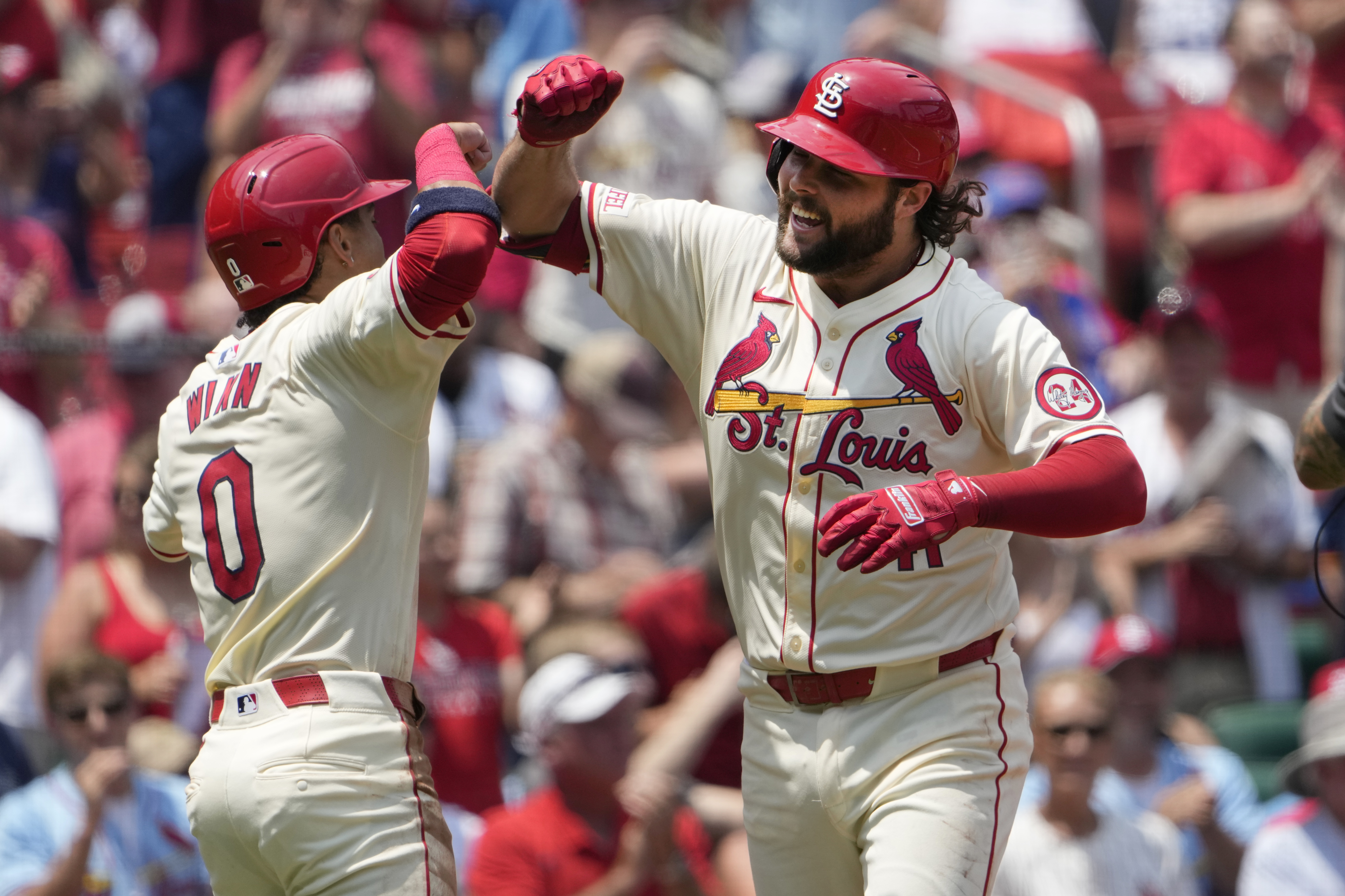 St. Louis Cardinals' Alec Burleson, right, is congratulated by teammate Masyn Winn after hitting a three-run home run during the first inning of a baseball game against the Chicago Cubs Saturday, July 13, 2024, in St. Louis. 
