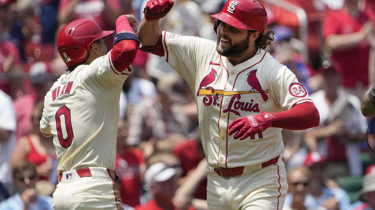 St. Louis Cardinals' Alec Burleson, right, is congratulated by teammate Masyn Winn after hitting a three-run home run during the first inning of a baseball game against the Chicago Cubs Saturday, July 13, 2024, in St. Louis.