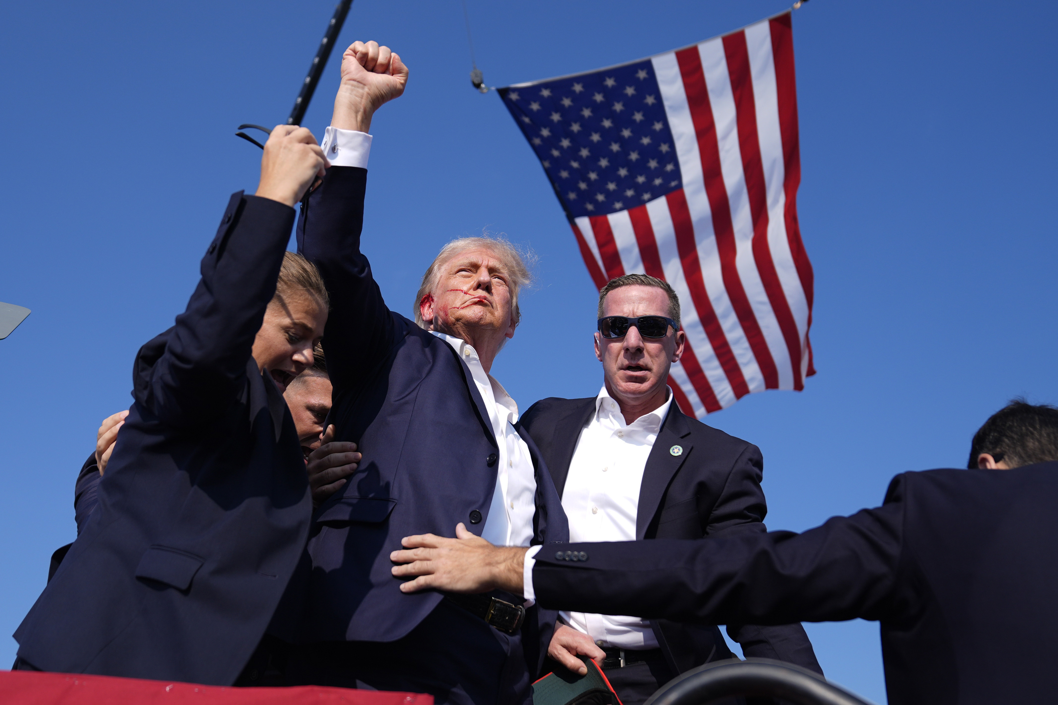 Republican presidential candidate former President Donald Trump is surrounded by U.S. Secret Service agents at a campaign rally, Saturday, in Butler, Pa.