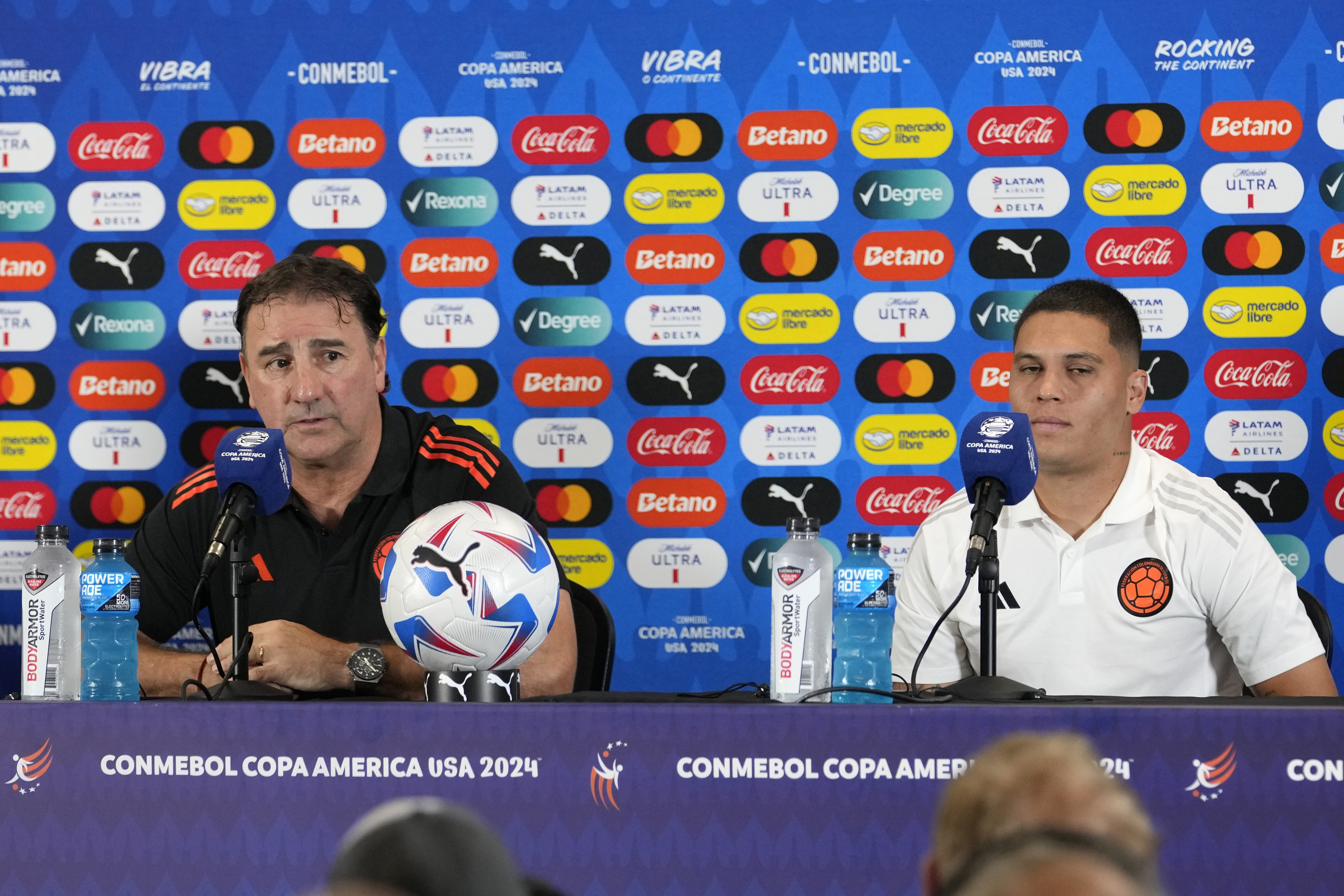 Colombia head coach Nestor Lorenzo, left, and midfielder Juan Fernando Quintero, right, speak during a Copa America soccer news conference, Saturday, July 13, 2024, in Miami Gardens, Fla. Colombia plays Argentina in the final Sunday. 