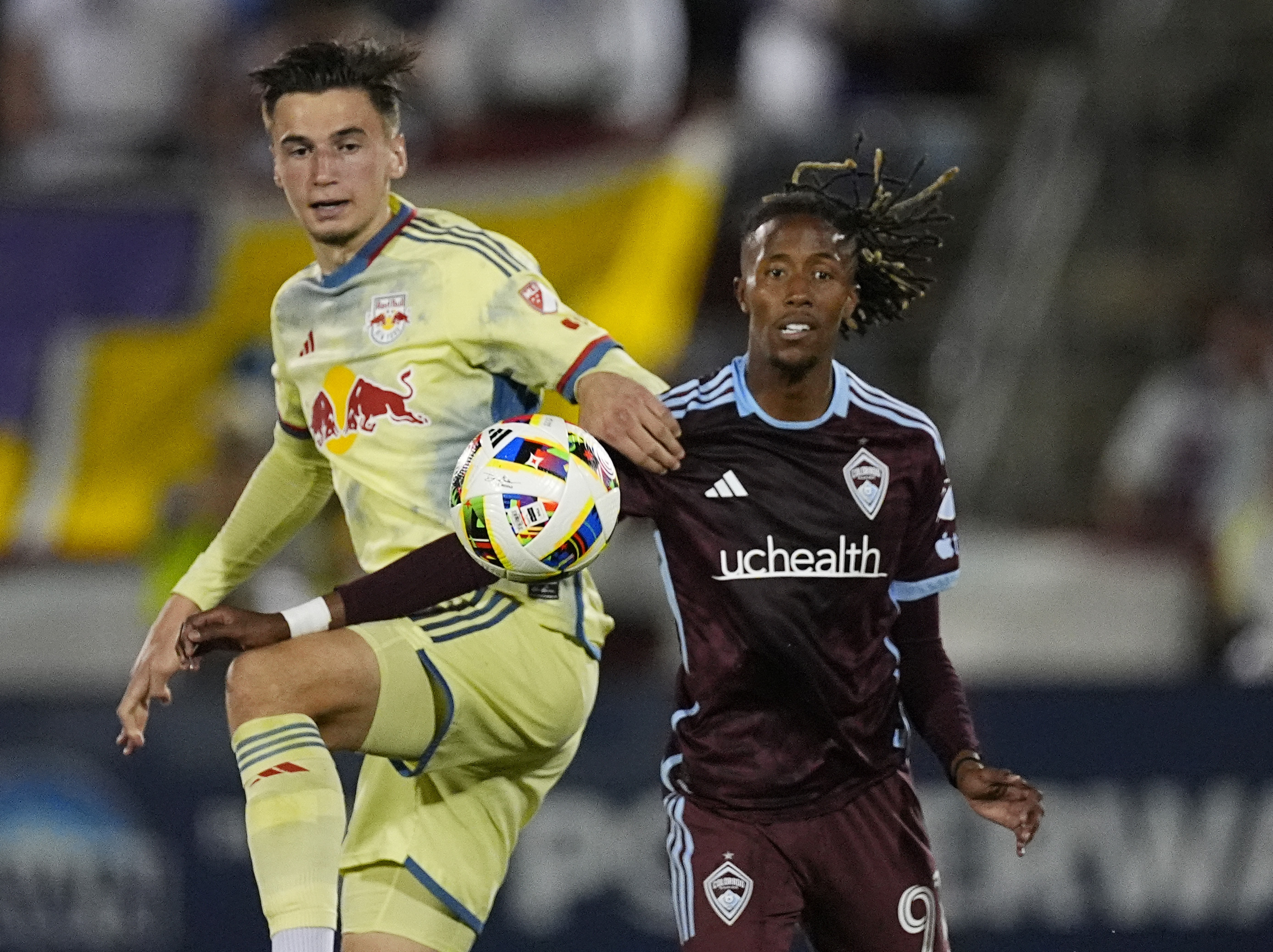 New York Red Bulls defender Noah Eile, left, and Colorado Rapids forward Kévin Cabral, right, pursue the ball in the second half of an MLS soccer match Saturday, July 13, 2024, in Commerce City, Colo. 