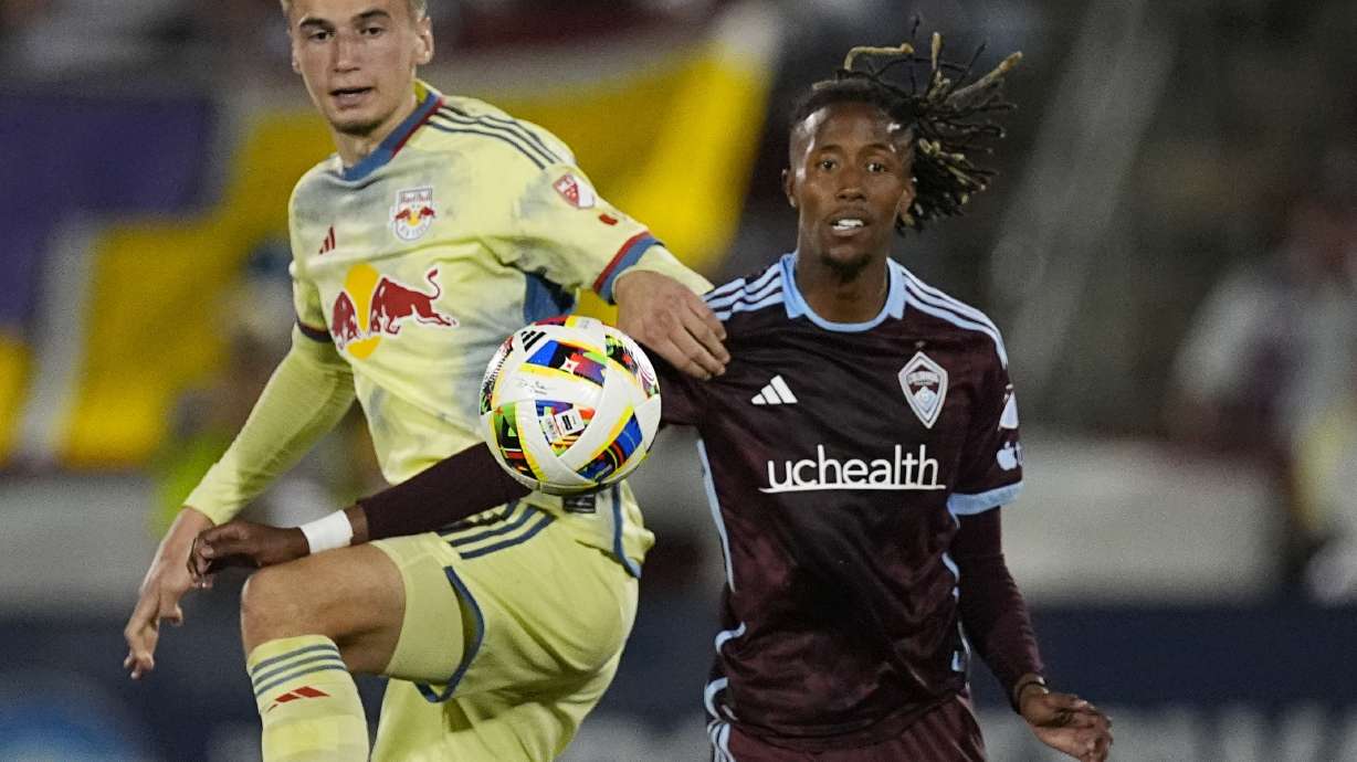 New York Red Bulls defender Noah Eile, left, and Colorado Rapids forward Kévin Cabral, right, pursue the ball in the second half of an MLS soccer match Saturday, July 13, 2024, in Commerce City, Colo.