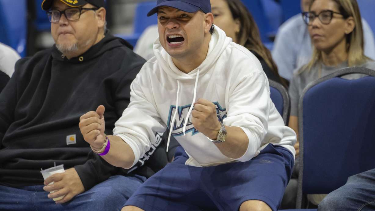 Reggaeton singer Jowell cheers during a basketball game between the Guaynabo Mets and the Bayamón Vaqueros, at the Ruben Rodríguez Coliseum in Bayamón, Puerto Rico, Monday, July 1, 2024. Puerto Rico’s professional basketball league is experiencing a renaissance thanks to reggaeton stars like Bad Bunny, Ozuna and Anuel AA, who are stepping into the financial game, buying local teams and helping to stack up a loyal fan base.