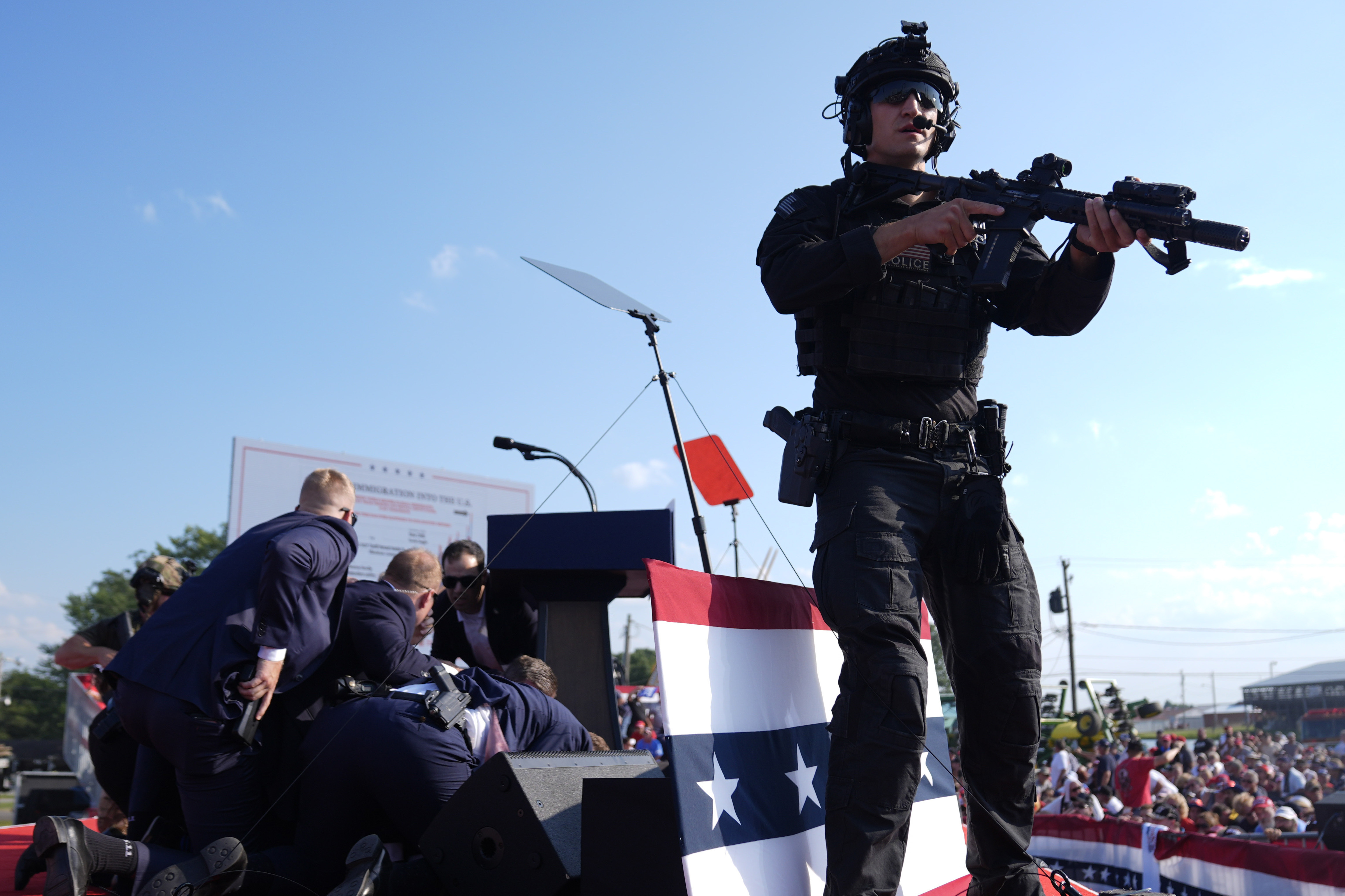 Republican presidential candidate former President Donald Trump is covered by U.S. Secret Service agents at a campaign rally, Saturday, in Butler, Pa.