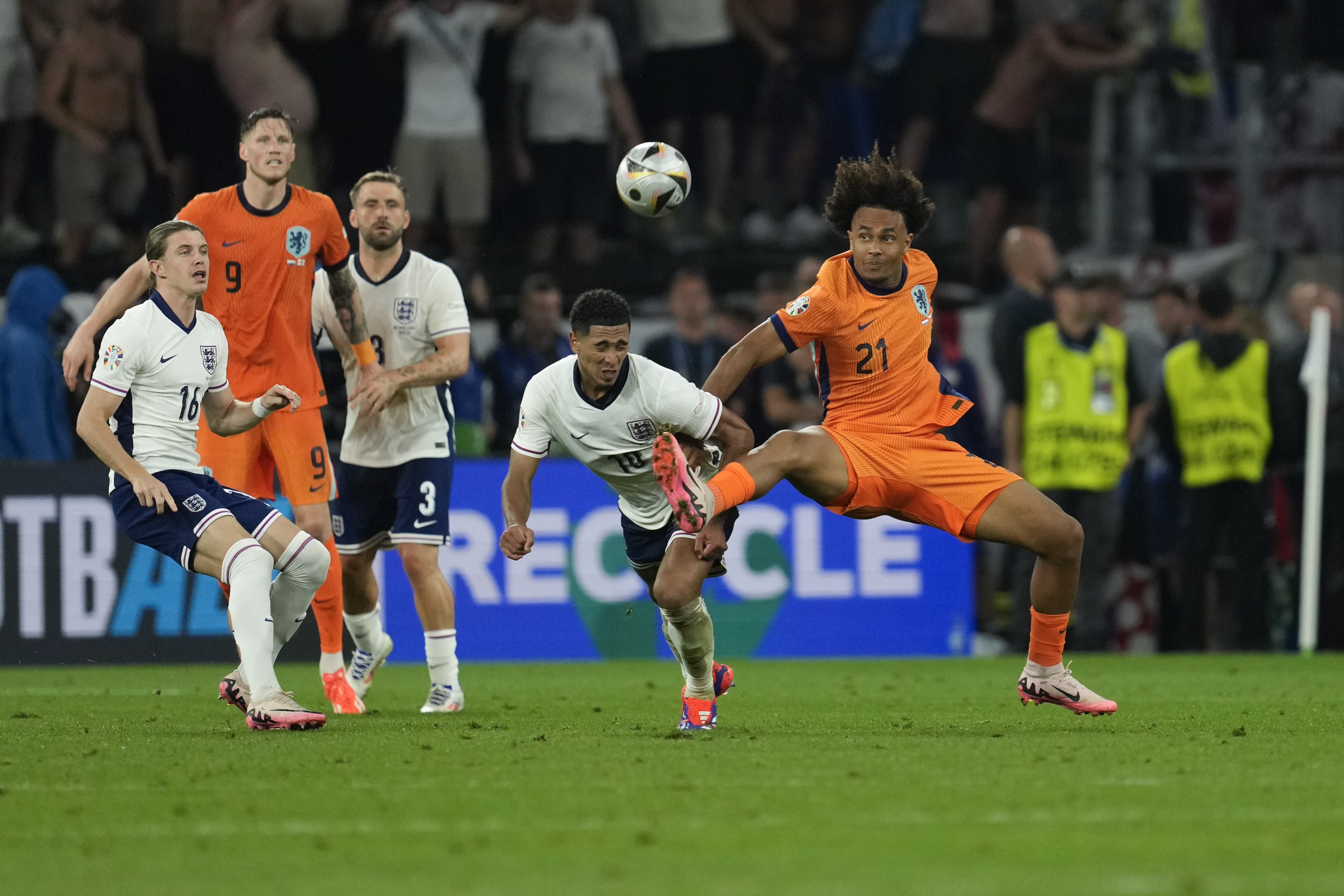 Netherlands's Joshua Zirkzee right, challenges England's Jude Bellingham during a semifinal match between the Netherlands and England at the Euro 2024 soccer tournament in Dortmund, Germany, Wednesday, July 10, 2024. 