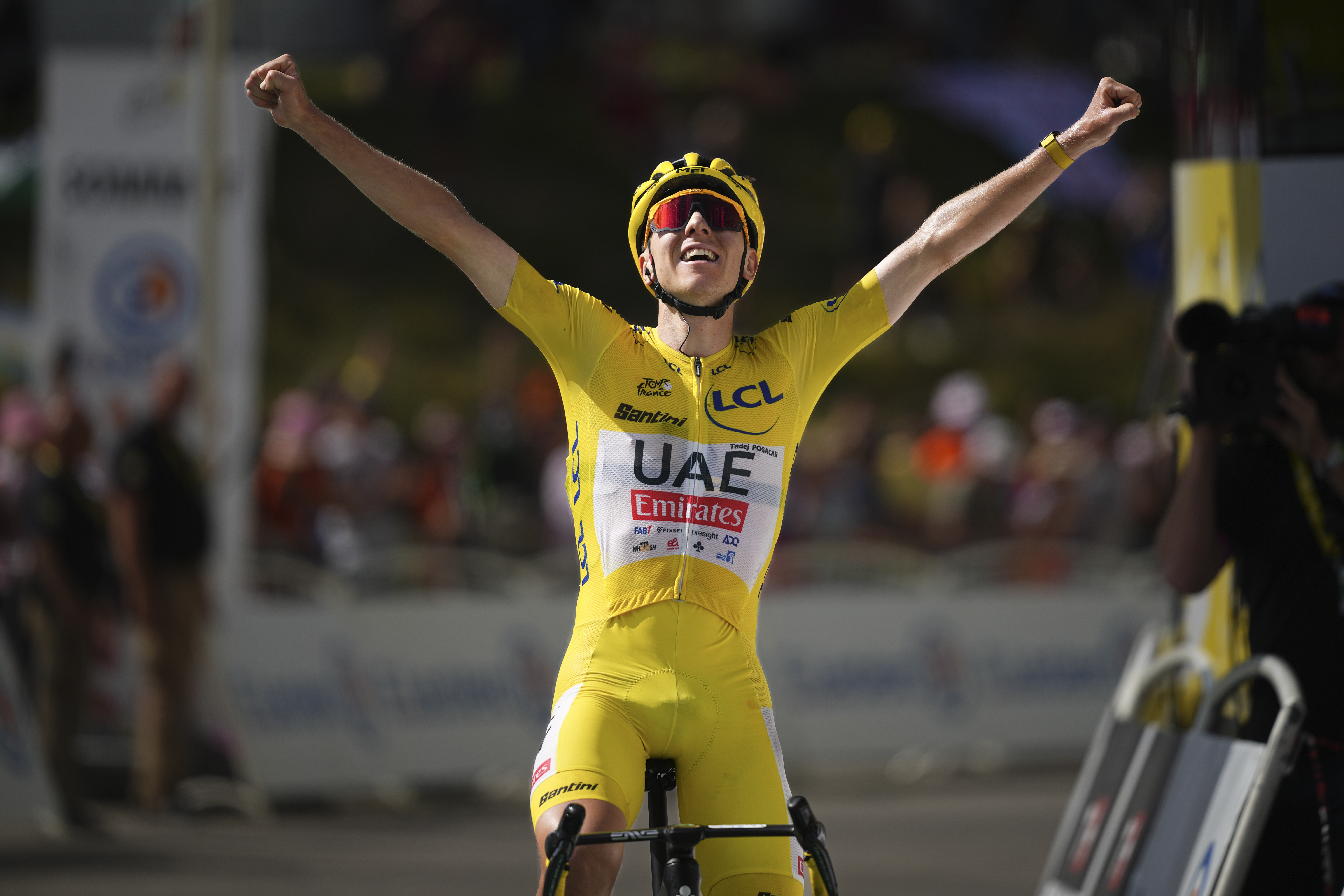 Stage winner Slovenia's Tadej Pogacar, wearing the overall leader's yellow jersey, celebrates as he crosses the finish line of the fifteenth stage of the Tour de France cycling race over 198 kilometers (123 miles) with start in Loudenvielle and finish on Plateau de Beille, France, Sunday, July 14, 2024. 