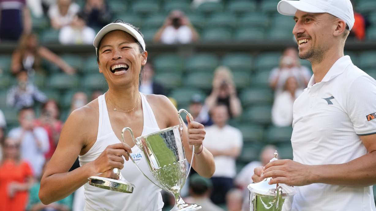 Taiwan's Su-Wei Hsieh and Poland's Jan Zielinski react with their trophy's after defeating Mexico's Santiago Gonzalez and compatriot Giuliana Olmos in the mixed doubles final at the Wimbledon tennis championships in London, Sunday, July 14, 2024.