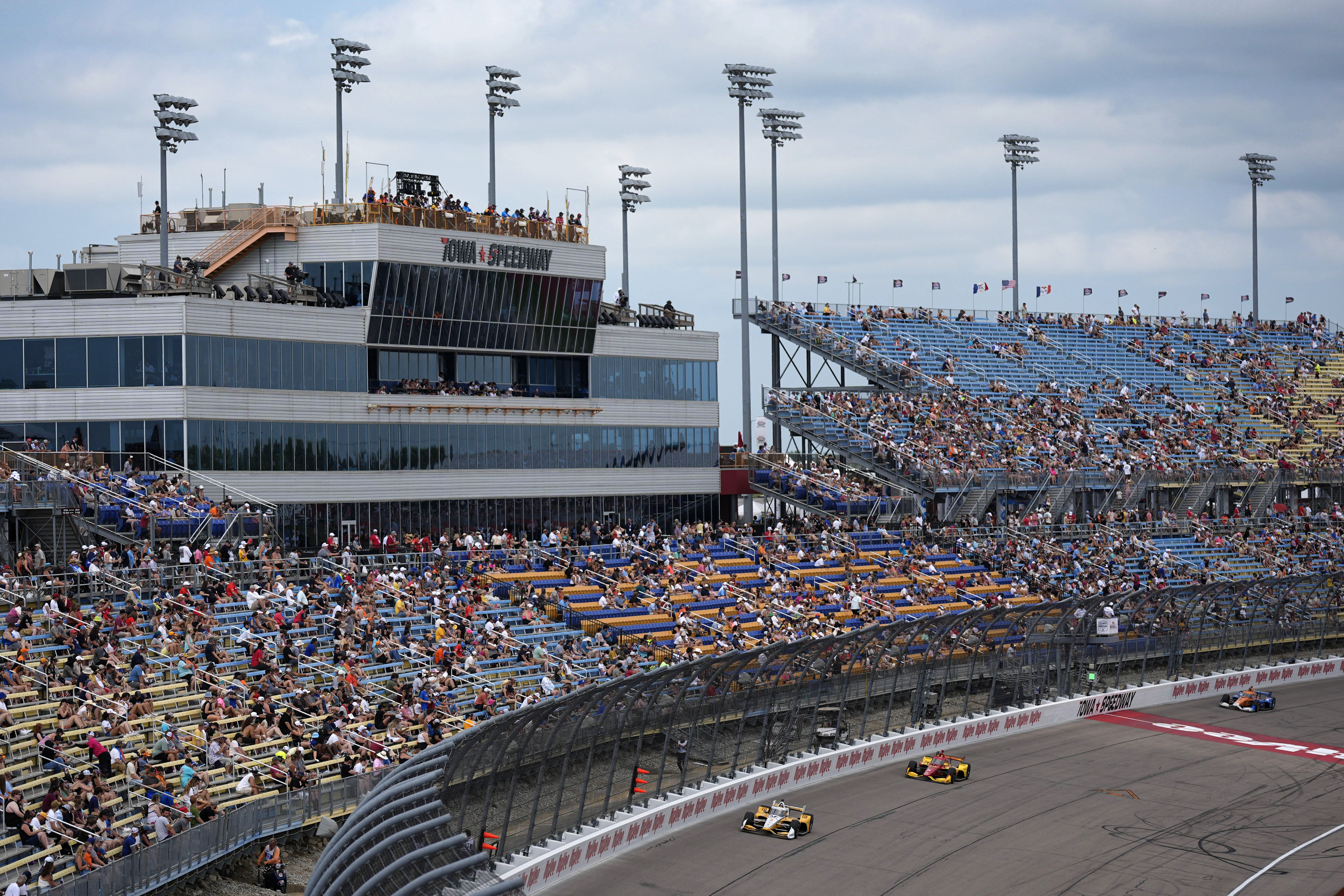 Scott McLaughlin, left, leads during an IndyCar auto race, Sunday, July 14, 2024, at Iowa Speedway in Newton, Iowa.