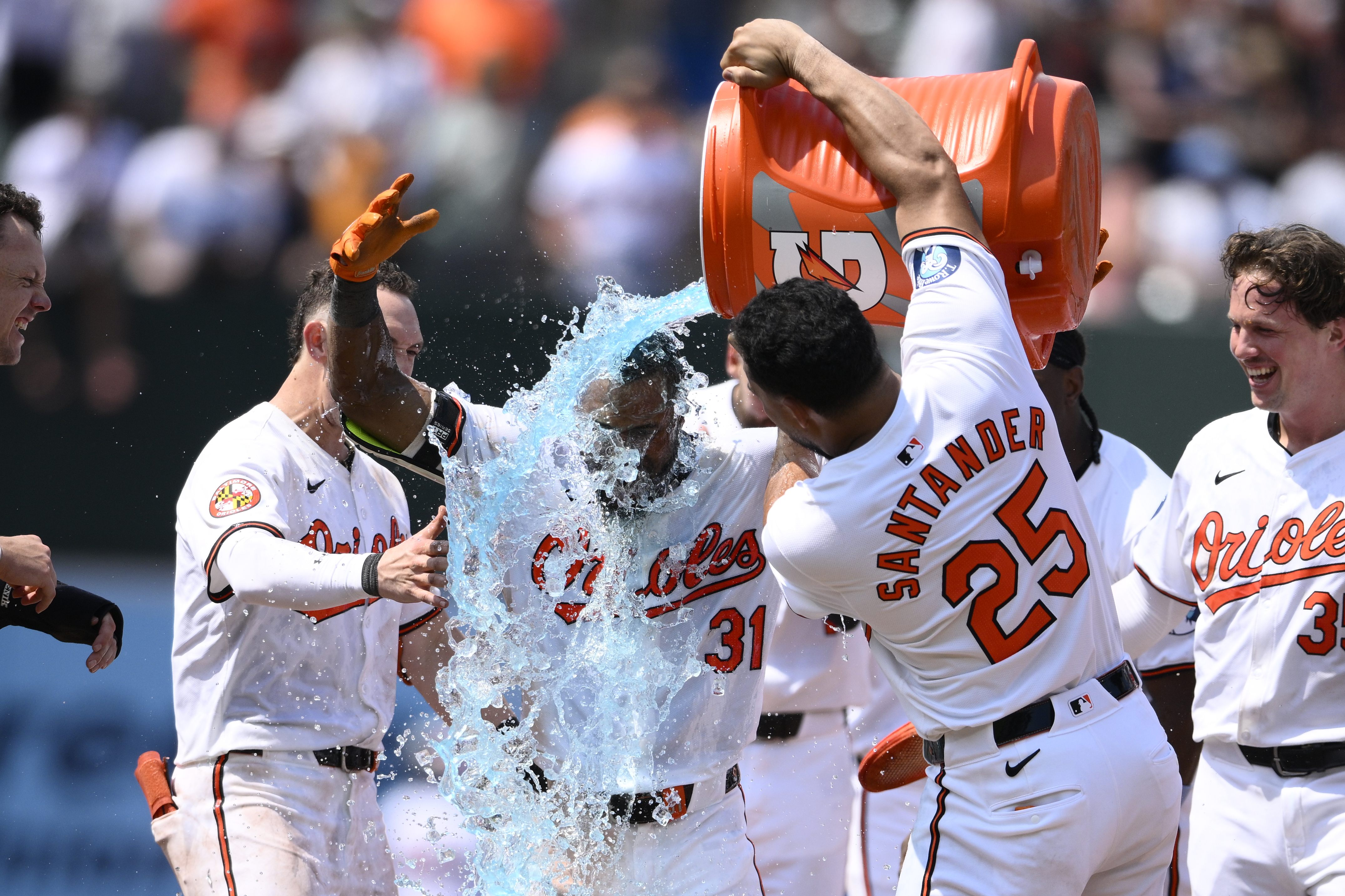 Baltimore Orioles' Cedric Mullins (31) gets doused by Anthony Santander (25) after Mullins hit a two RBI walk-off double to win a baseball game against the New York Yankees, Sunday, July 14, 2024, in Baltimore. The Orioles won 6-5. 