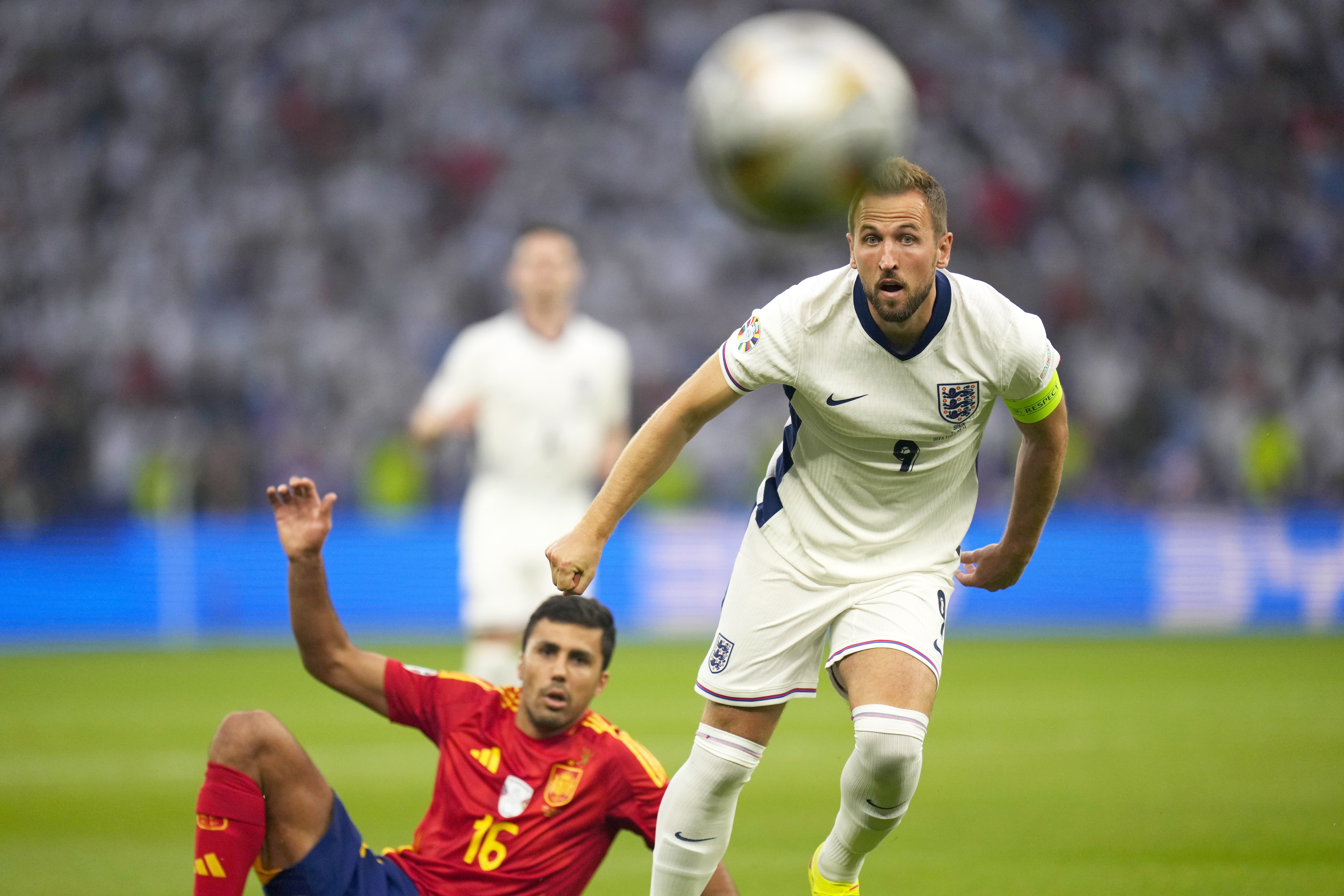 England's Harry Kane, right, and Spain's Rodri eye the ball during the final match between Spain and England at the Euro 2024 soccer tournament in Berlin, Germany, Sunday, July 14, 2024.