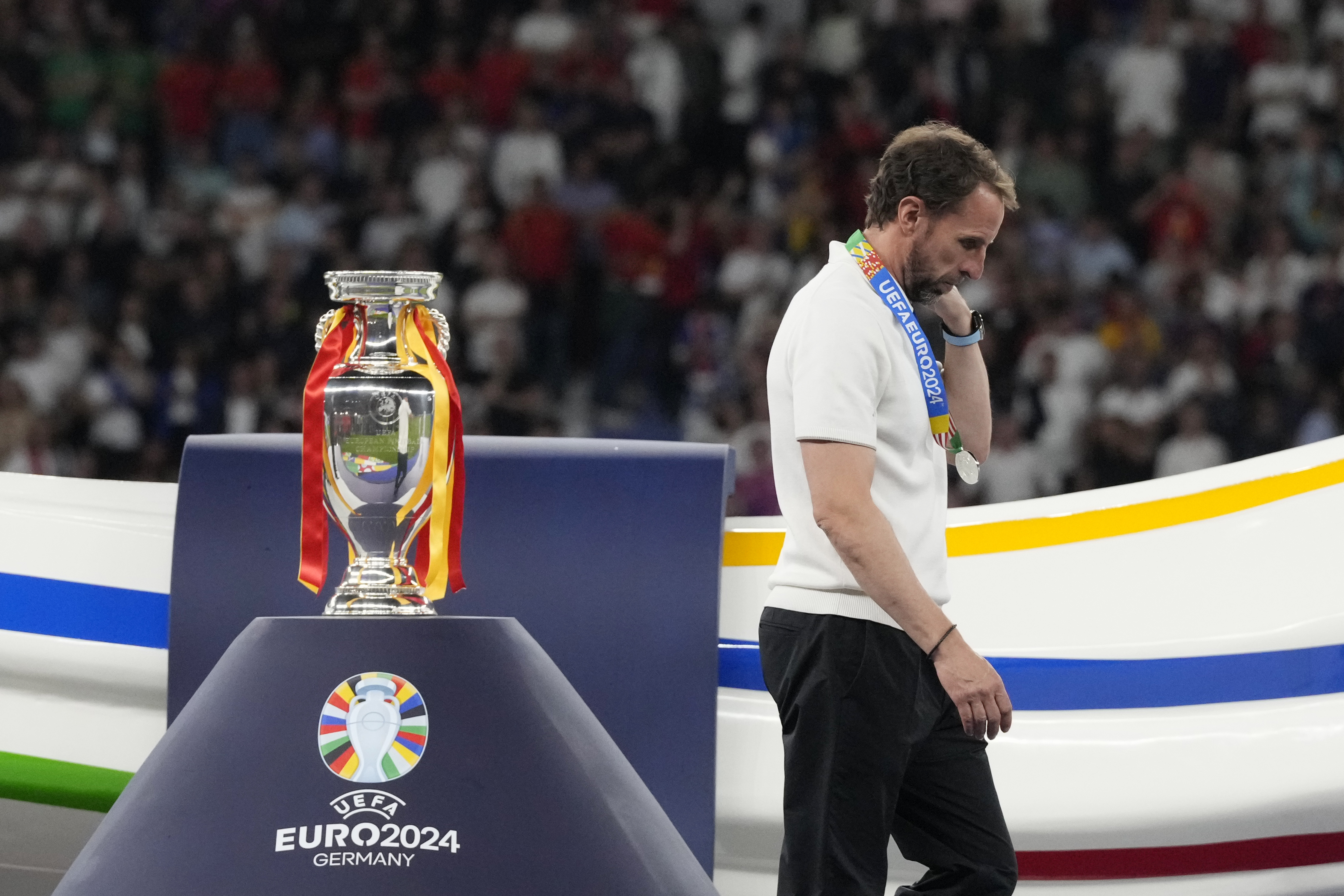 England's manager Gareth Southgate walks past the trophy at the end of the final match between Spain and England at the Euro 2024 soccer tournament in Berlin, Germany, Sunday, July 14, 2024. Spain won 2-1. 