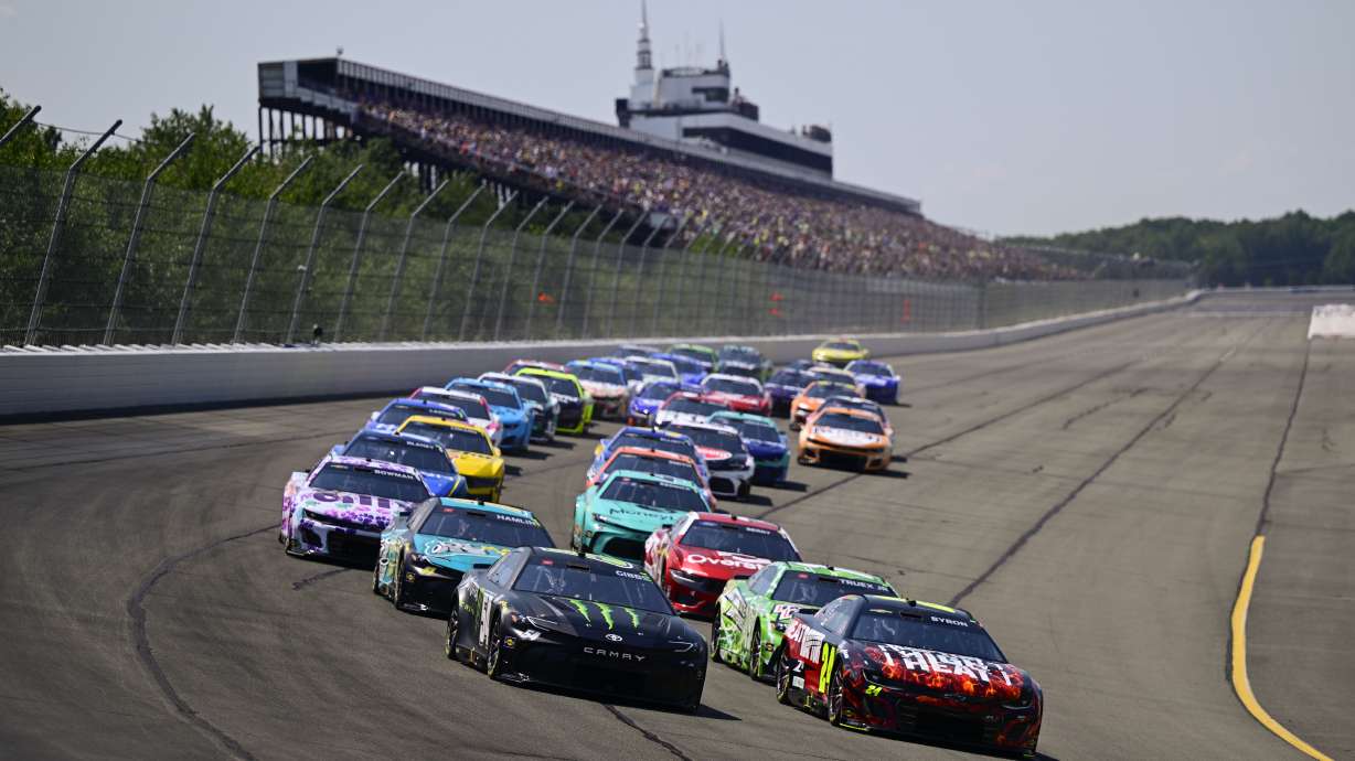 Ty Gibbs and William Byron lead the field into Turn 1 to start a NASCAR Cup Series auto race at Pocono Raceway, Sunday, July 14, 2024, in Long Pond, Pa.