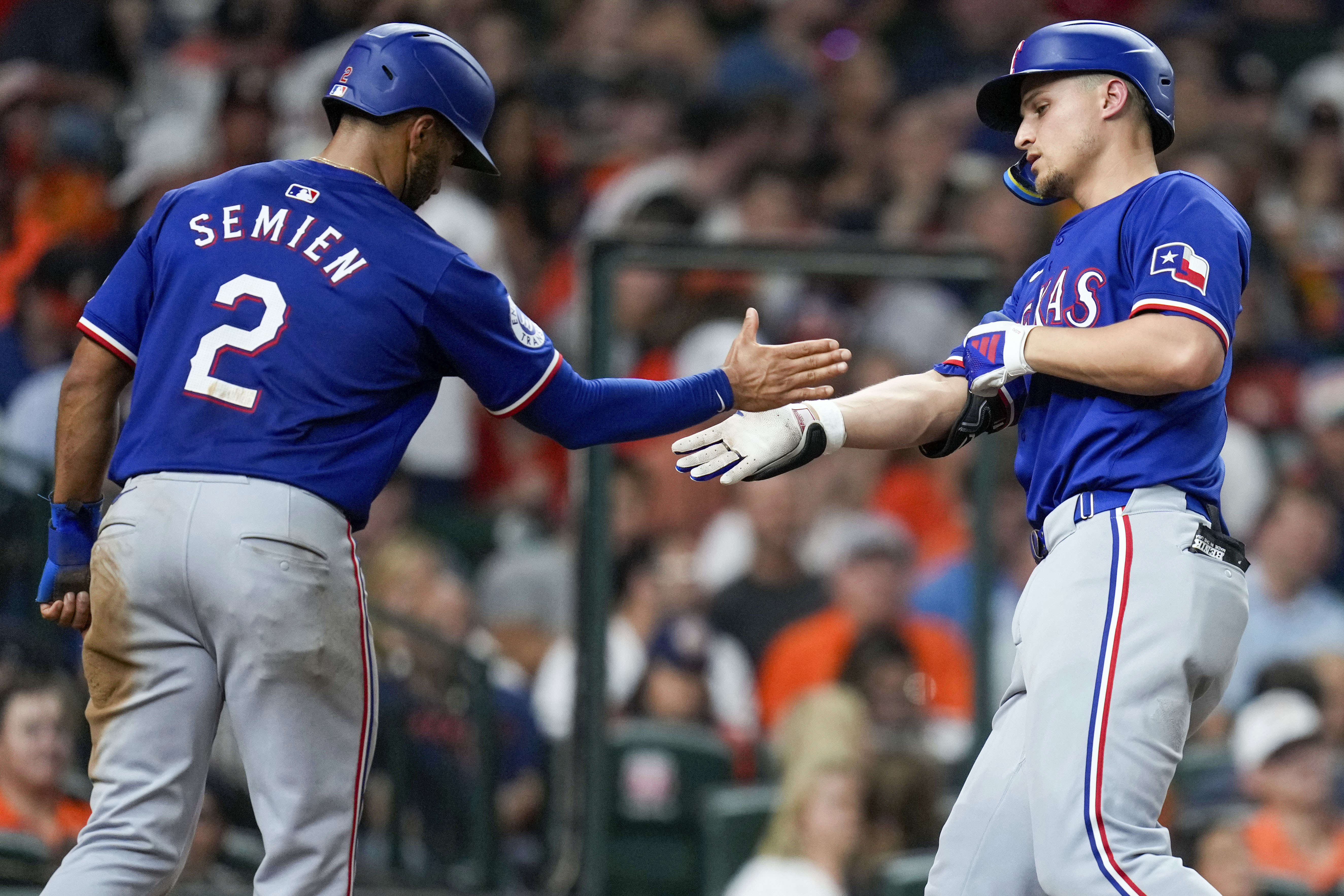 Texas Rangers' Corey Seager, right, celebrates after his two-run home run with Marcus Semien during the sixth inning of a baseball game against the Houston Astros, Friday, July 12, 2024, in Houston.