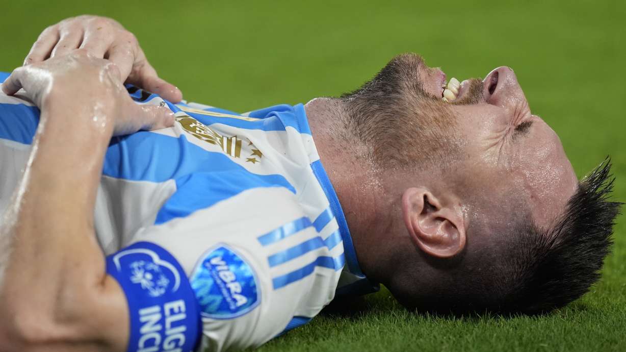 Argentina's Lionel Messi grimaces during the Copa America final soccer match against Colombia in Miami Gardens, Fla., Sunday, July 14, 2024.
