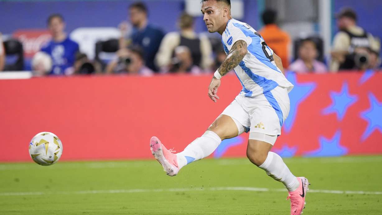 Argentina's Lautaro Martínez scores his side's first goal against Colombia during the Copa America final soccer match in Miami Gardens, Fla., Sunday, July 14, 2024.