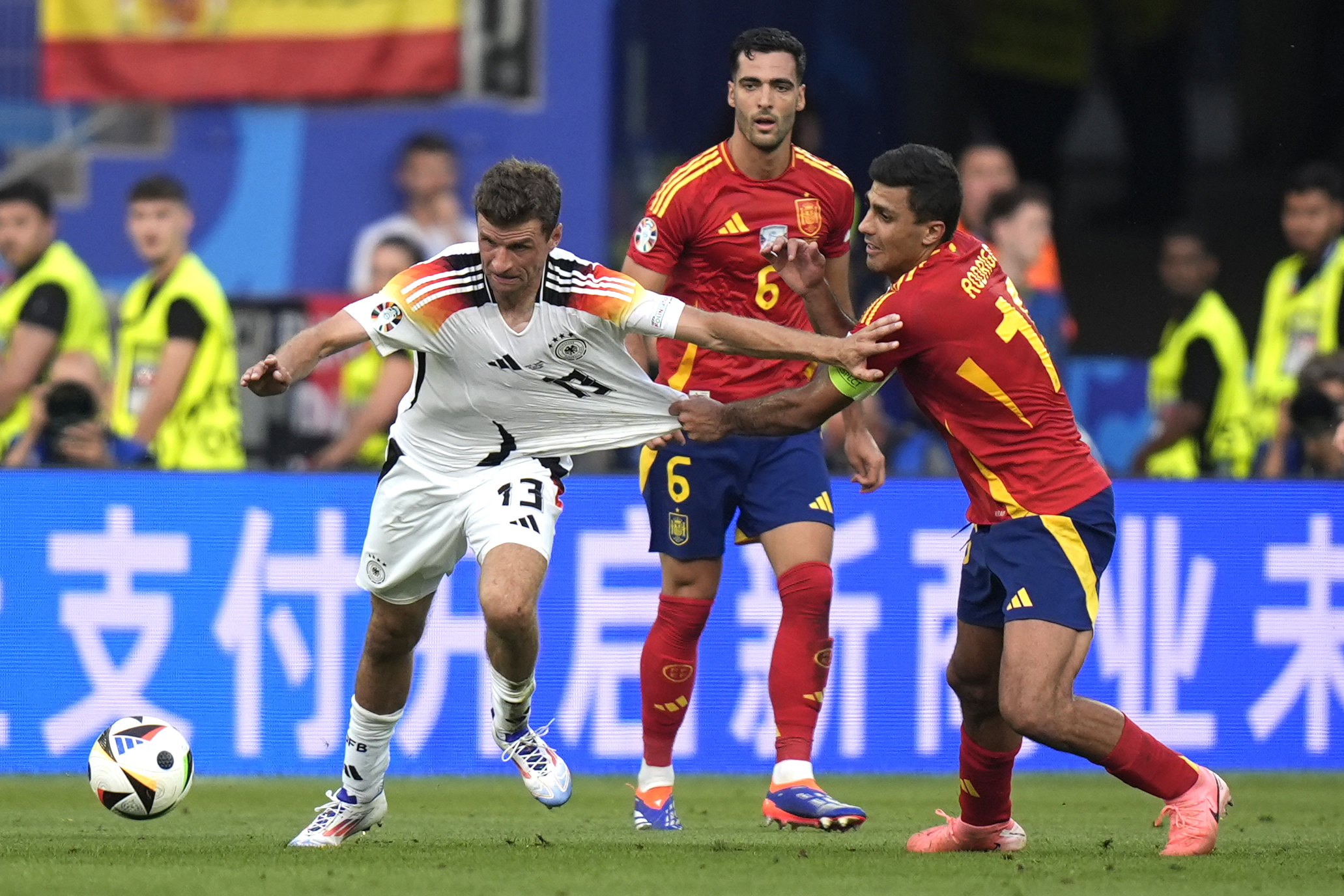 Germany's Thomas Mueller, left, and Spain's Rodri vie for the ball during a quarter final match between Germany and Spain at the Euro 2024 soccer tournament in Stuttgart, Germany, Friday, July 5, 2024. 