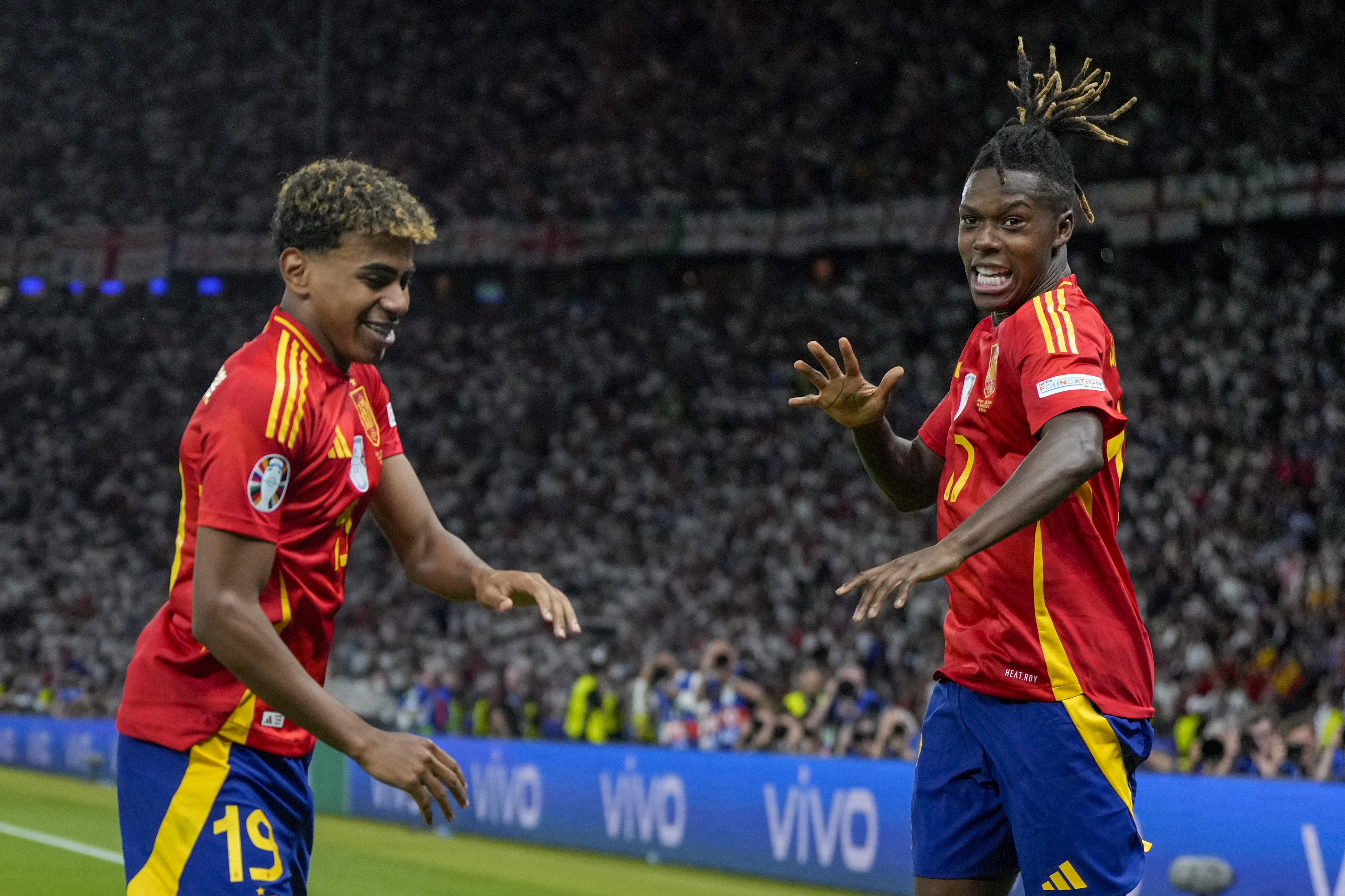 Spain's Nico Williams, right, celebrates with his teammate Lamine Yamal after scoring his side's opening goal during the final match between Spain and England at the Euro 2024 soccer tournament in Berlin, Germany, Sunday, July 14, 2024. 