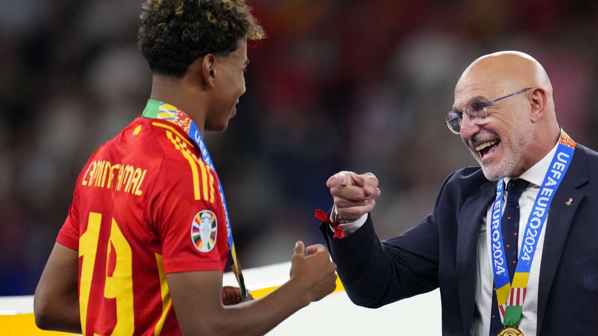 Spain's head coach Luis de la Fuente gestures to Lamine Yamal after they collected their medals for winning the final match between Spain and England at the Euro 2024 soccer tournament in Berlin, Germany, Sunday, July 14, 2024. Spain won 2-1.