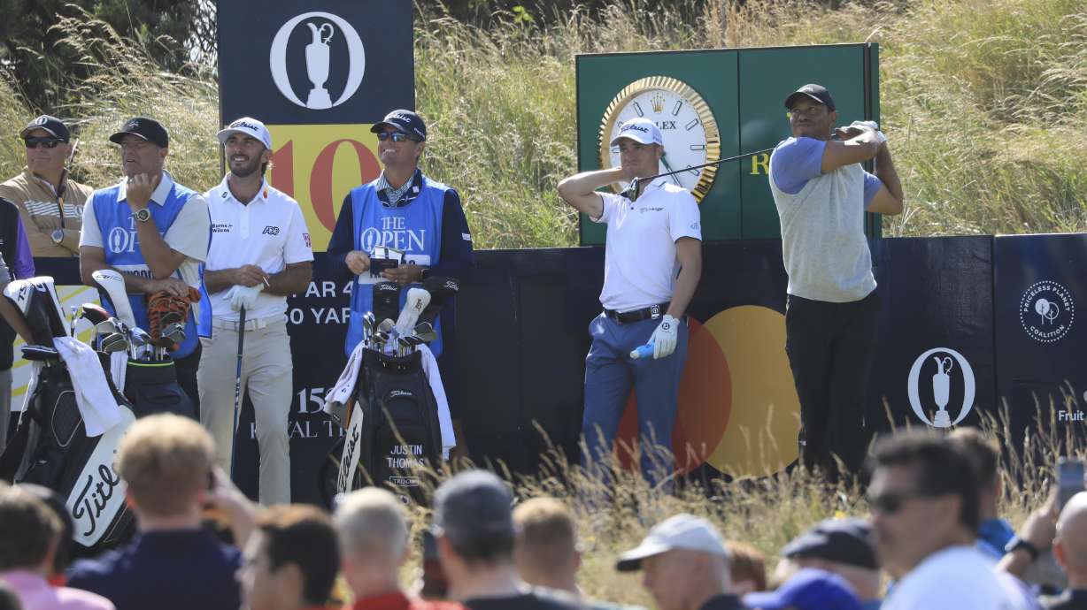 Tiger Woods of the United States, right, tees off the 10th hole during a practice round for the British Open Golf Championships at the Royal Troon golf club in Troon, Scotland, Monday, July 15, 2024.