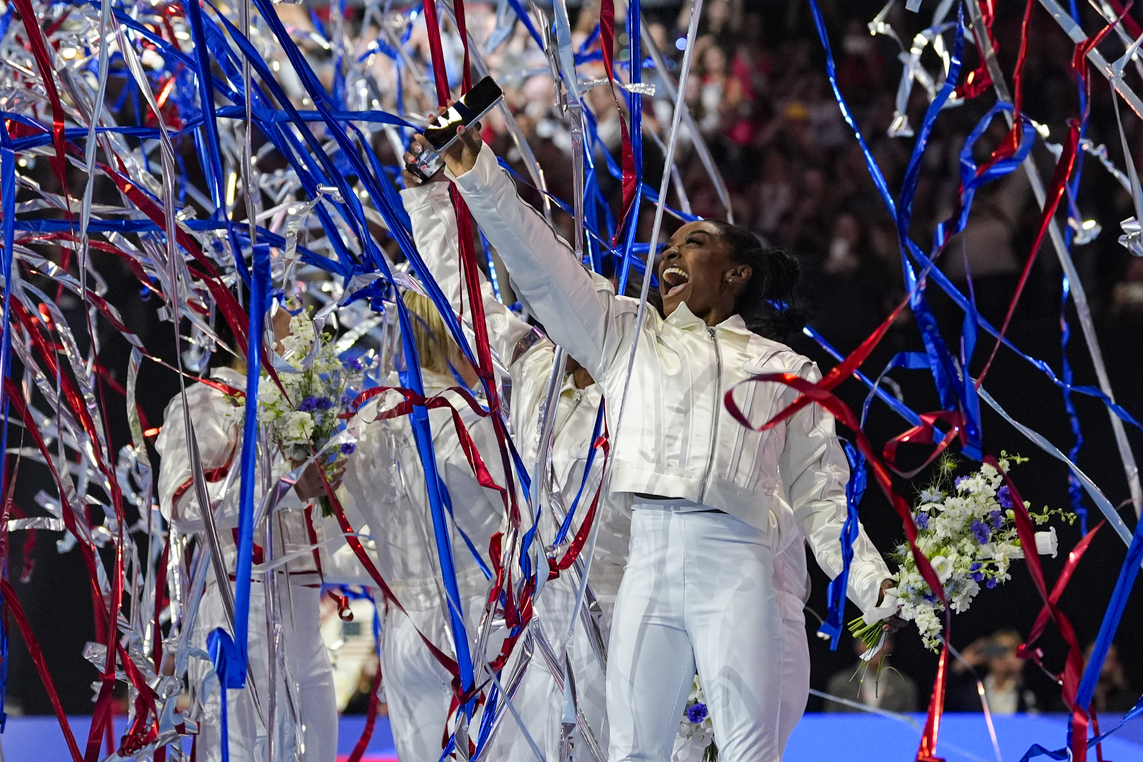 FILE - Simone Biles and the U.S. women celebrate as the 2024 team is named at the United States Gymnastics Olympic Trials on Sunday, June 30, 2024, in Minneapolis. 