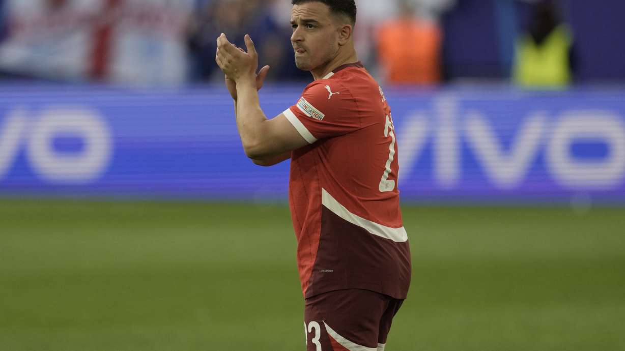 Switzerland's Xherdan Shaqiri acknowledges the applause from their supporters after their loss in the quarterfinal match against England at the Euro 2024 soccer tournament in Duesseldorf, Germany, Saturday, July 6, 2024.