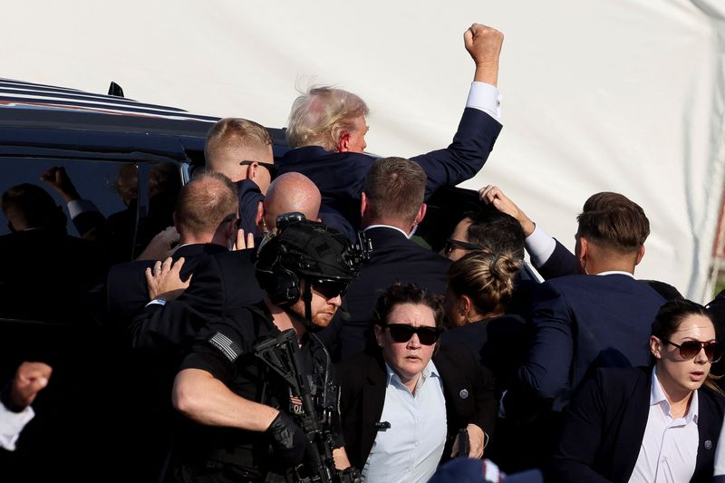 Republican presidential candidate and former president Donald Trump gets into a vehicle with the assistance of Secret Service personnel after he was shot in the right ear during a campaign rally in Butler, Penn., Saturday.