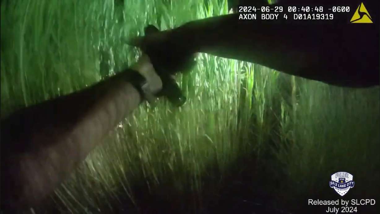 Body camera video released Monday shows the moment a Salt Lake police officer fired his gun while looking for a man who had run from officers and was believed to be hiding in thick tall grass.