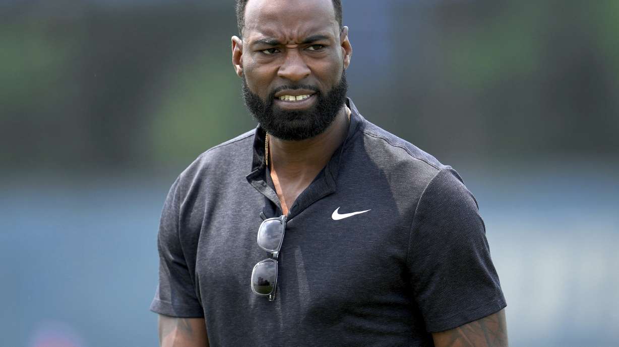FILE - Former Detroit Lions wide receiver Calvin Johnson walks off the field after an NFL football practice in Allen Park, Mich., June 8, 2023. Pro Football Hall of Famer Johnson was chosen for induction into the Pride of the Lions, an honor that will put his name on permanent display at Ford Field. Lions chief operating officer Mike Disner surprised Johnson with the team’s plans Monday, July 15, 2024.
