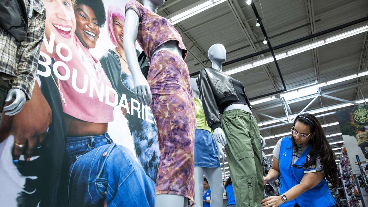 A Walmart employee works on a display of the No Boundaries collection in Secaucus, New Jersey, Thursday. The retailer has revamped its store brand for young adults called No Boundaries, which generates annual sales of $2 billion.