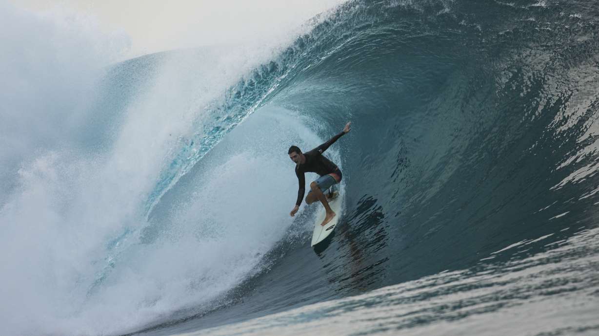 FILE - A surfer rides a wave in Teahupo'o, Tahiti, French Polynesia, Saturday, Jan. 13, 2024. The world-famous surf spot is set to host the 2024 Paris Olympics surfing competition.