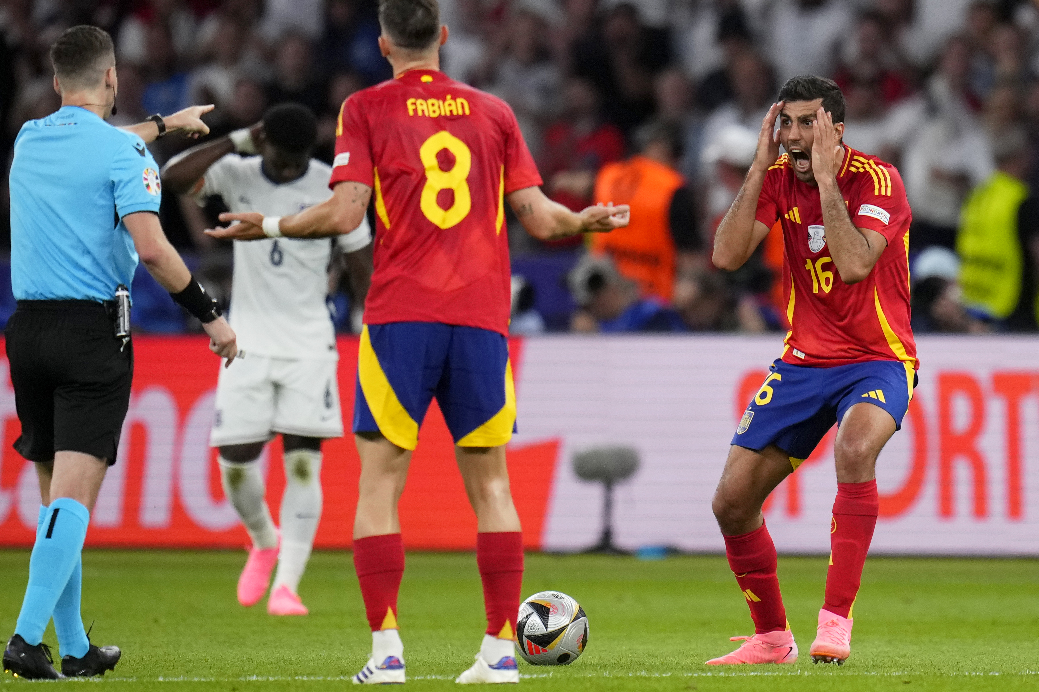 Spain's Rodri, right, reacts to a referee decision during the final match between Spain and England at the Euro 2024 soccer tournament in Berlin, Germany, Sunday, July 14, 2024. 