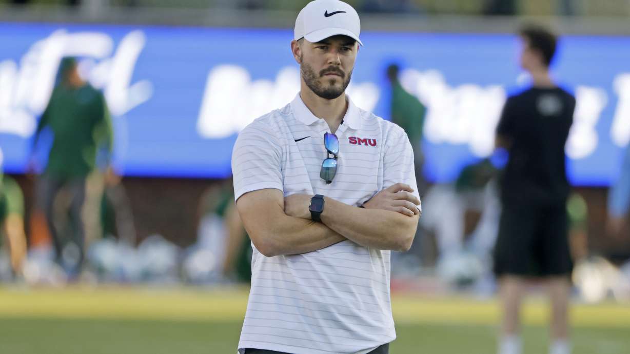 FILE - Then-SMU offensive coordinator Garrett Riley watches players practice prior to playing Tulane during an NCAA college football game in Dallas, Thursday, Oct. 22, 2021. Riley's offense in his first season at Clemson eventually kicked in, but far too late to make the Tigers championship contenders last season. Riley is focused on a faster, crisper start in year two.