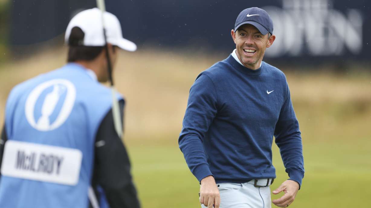 Rory McIlroy of Northern Ireland reacts with his caddy Harry Diamond during a practice round ahead of the British Open Golf Championships at Royal Troon golf club in Troon, Scotland, Tuesday, July 16, 2024.