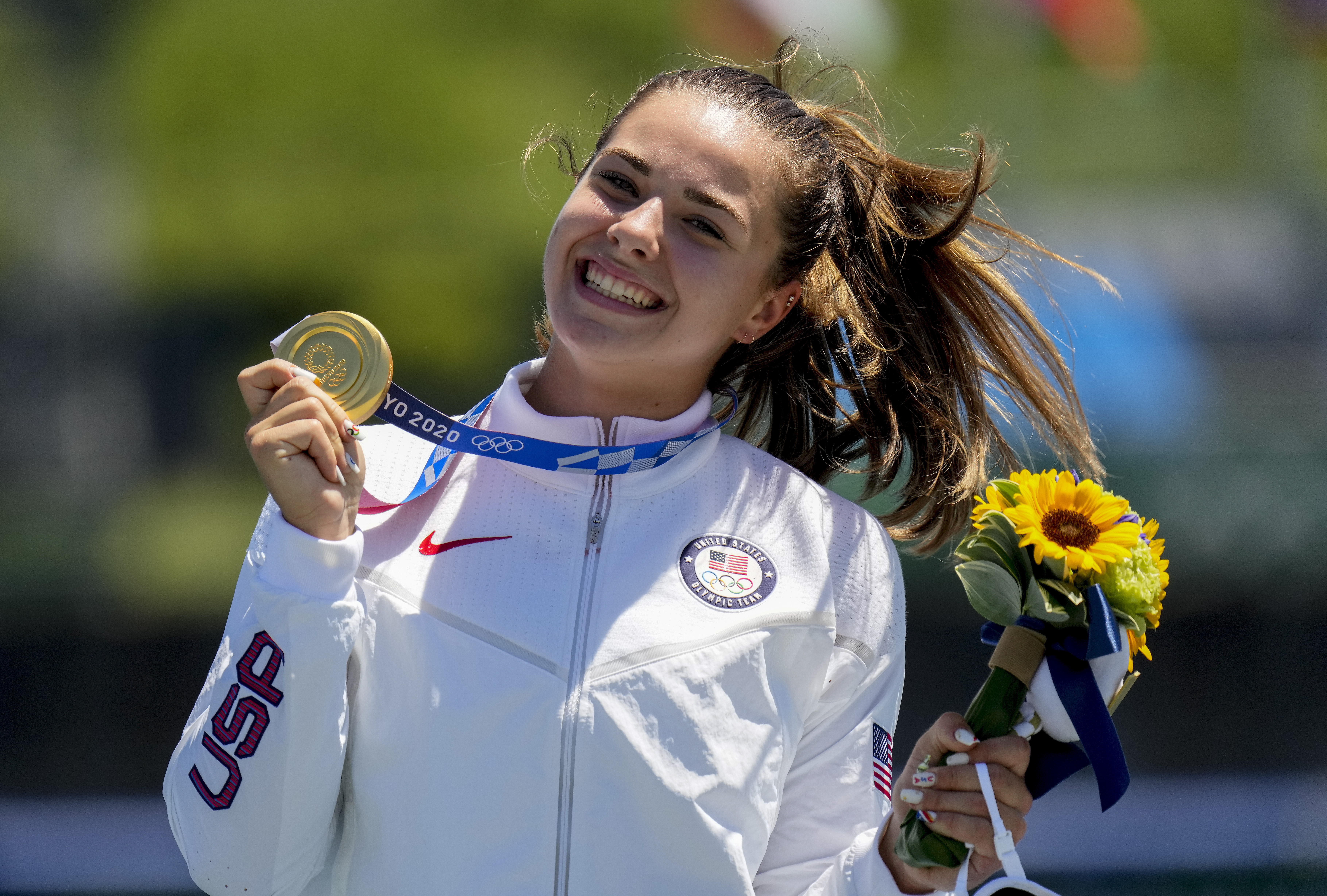 FILE - Nevin Harrison, of the United States, holds her up gold medal after winning the women's canoe single 200m final at the 2020 Summer Olympics, Thursday, Aug. 5, 2021, in Tokyo, Japan. Harrison is 22 years old and the defending Olympic gold medalist in canoe 200 sprint. She is a rock star in her sport and a certain threat to get back on the podium at the Paris Games.