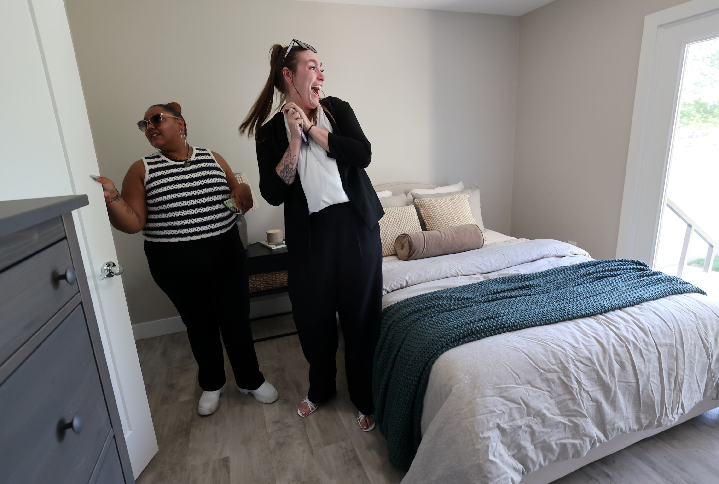 Maygan Martinez, Youth Action Board founder and former president, and Natalie Clark, Youth Action Board foster care liaison, check out a renovated Milestone Transitional Living Program house in Sandy on July 15. 