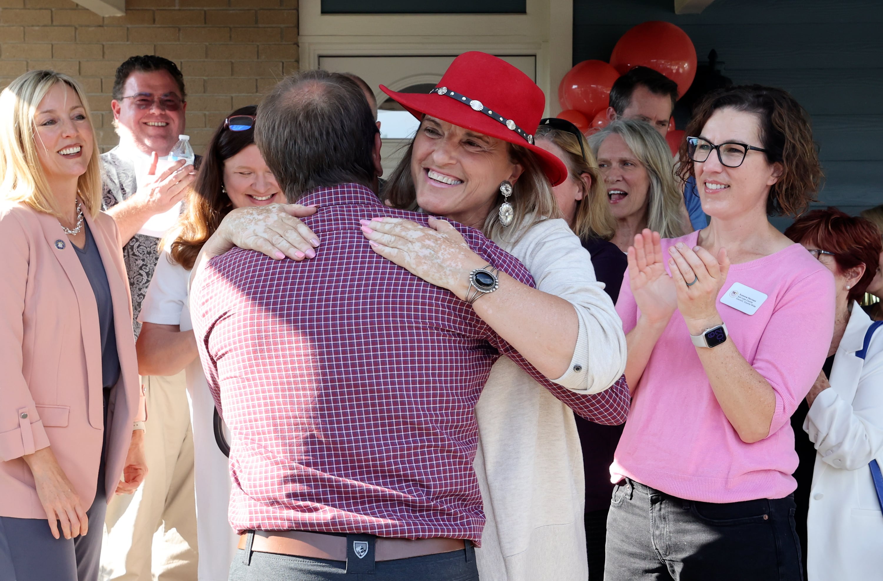 Former Sandy Councilman Chris McCandless hugs Sandy Mayor Monica Zoltanski at a ribbon-cutting ceremony for a Milestone Transitional Living Program house in Sandy on July 15.