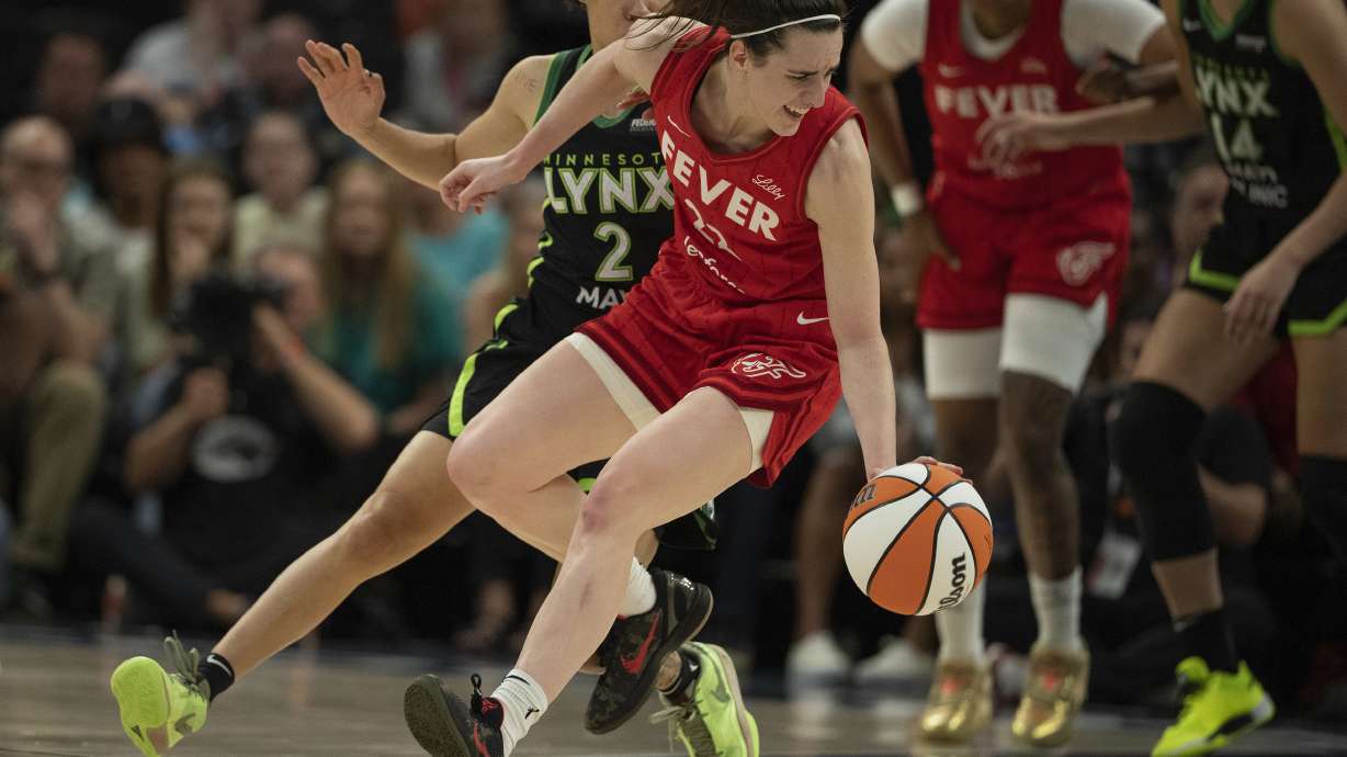 Minnesota Lynx guard Natisha Hiedeman (2) puts pressure on Indiana Fever guard Caitlin Clark (22) during the second quarter of a WNBA basketball game, Sunday, July 14, 2024, in Minneapolis.