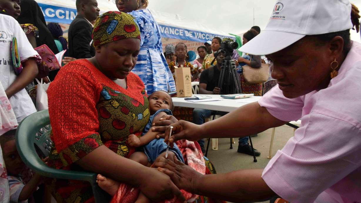 A health worker administers the malaria vaccine Oxford-Serum R21 to a child in Abidjan, Ivory Coast, July 15.
