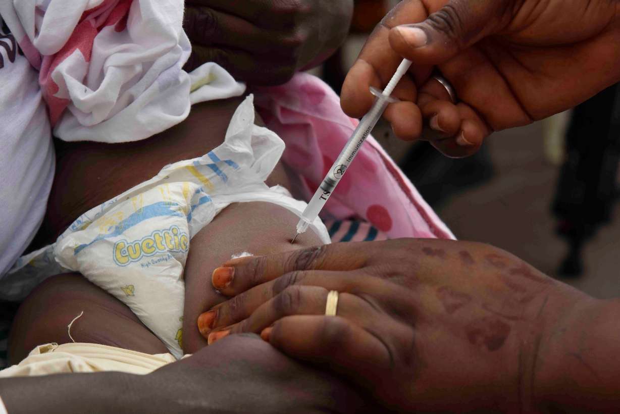A health worker administers the malaria vaccine Oxford-Serum R21 to a child in Abidjan, Ivory Coast, July 15.
